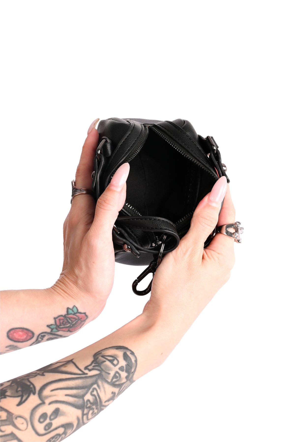 mini black bag with hand design on front and back with keychain attachment on handles