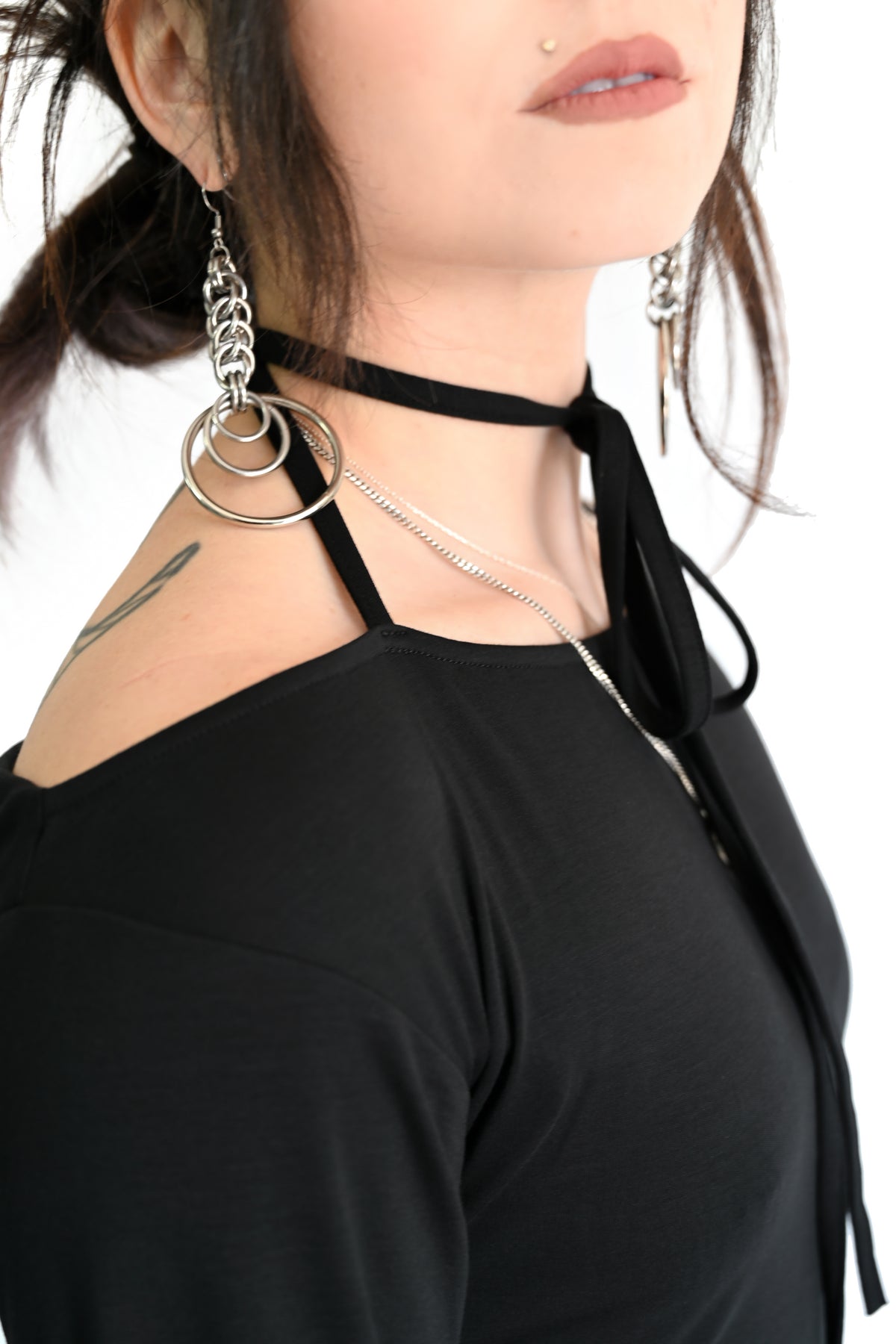 black asymmetrical top with adjustable tie neckline and long sleeves