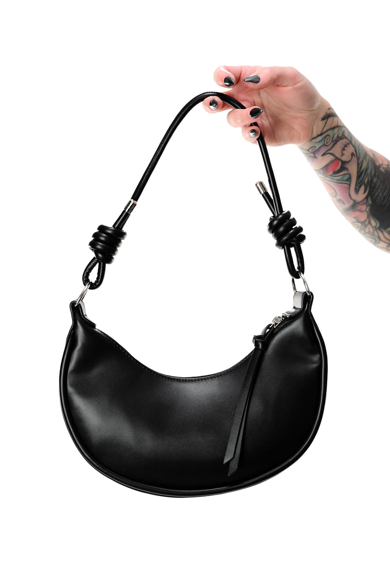 black faux leather crescent bag with knotted shoulder strap