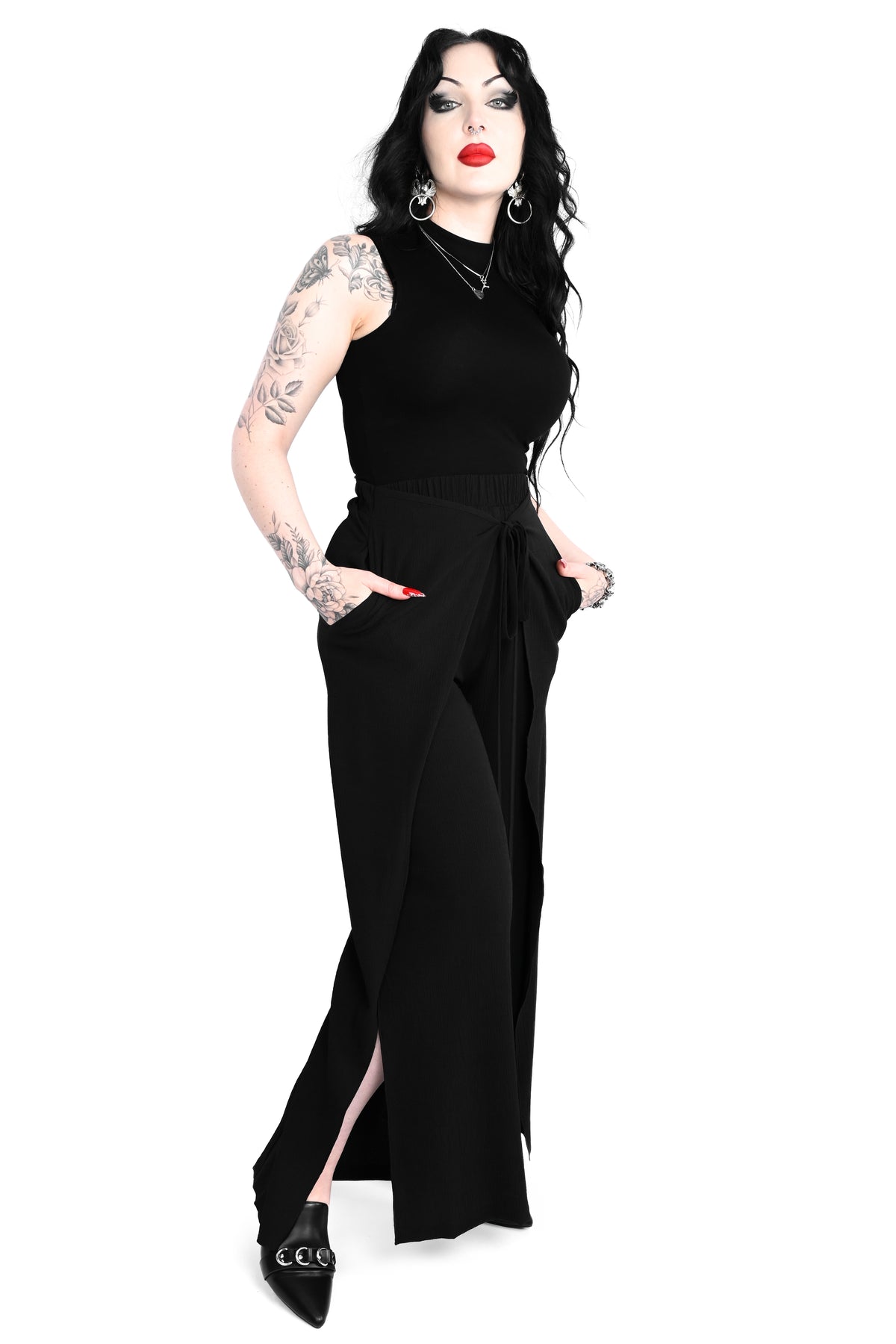 Black wide leg pants featuring a a wrap waist with adjustable tie.