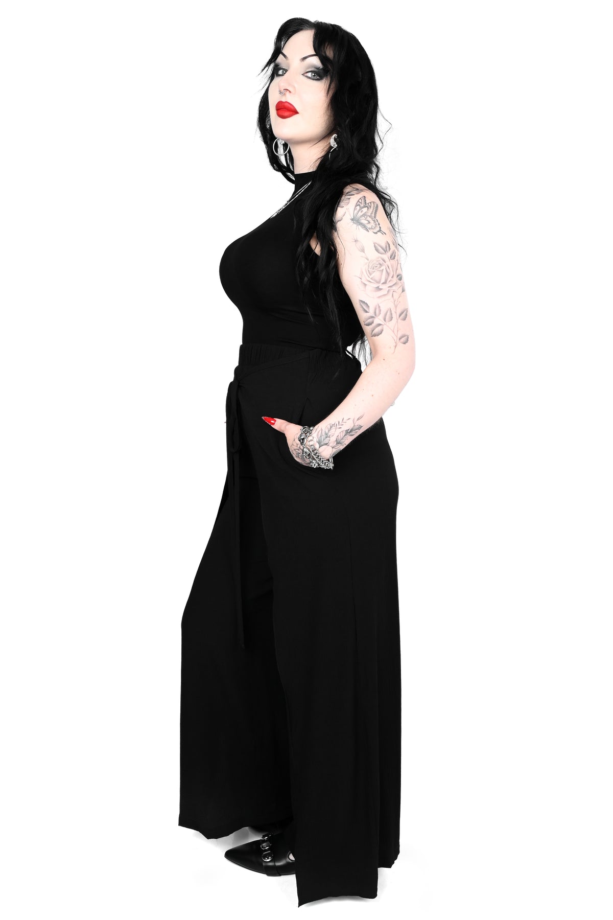 Black wide leg pants featuring a a wrap waist with adjustable tie.
