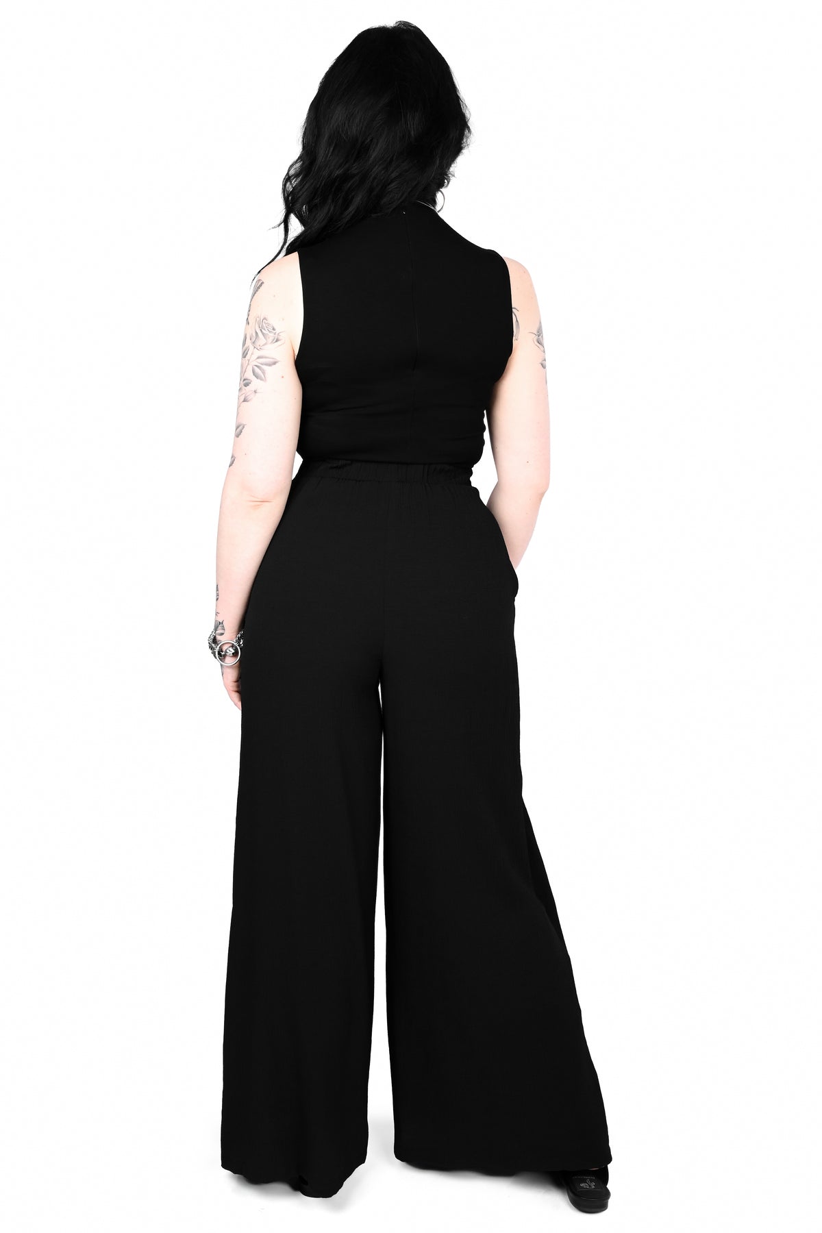 Black wide leg pants featuring a a wrap waist with adjustable tie.