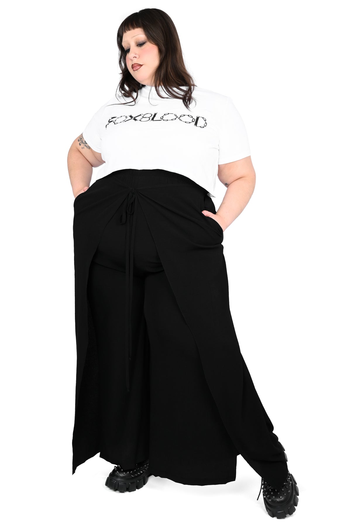Black wide leg pants featuring a a wrap waist with adjustable tie.