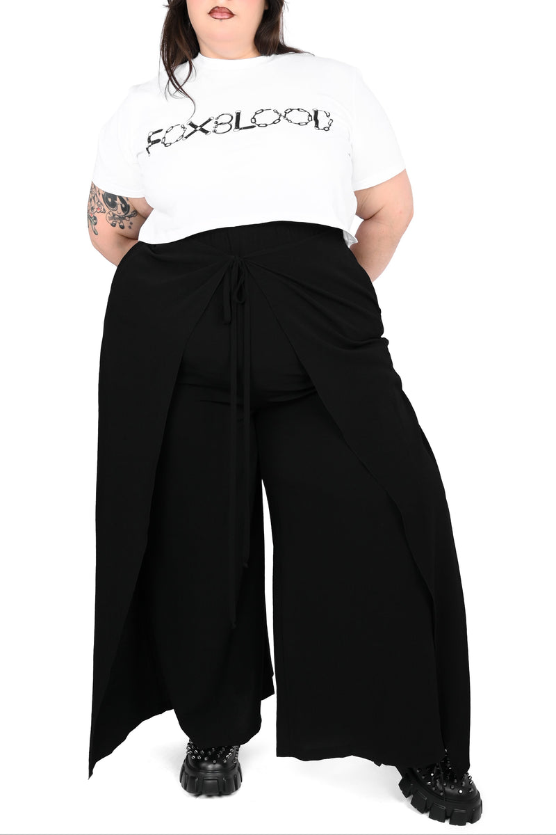 Black wide leg pants featuring a a wrap waist with adjustable tie.