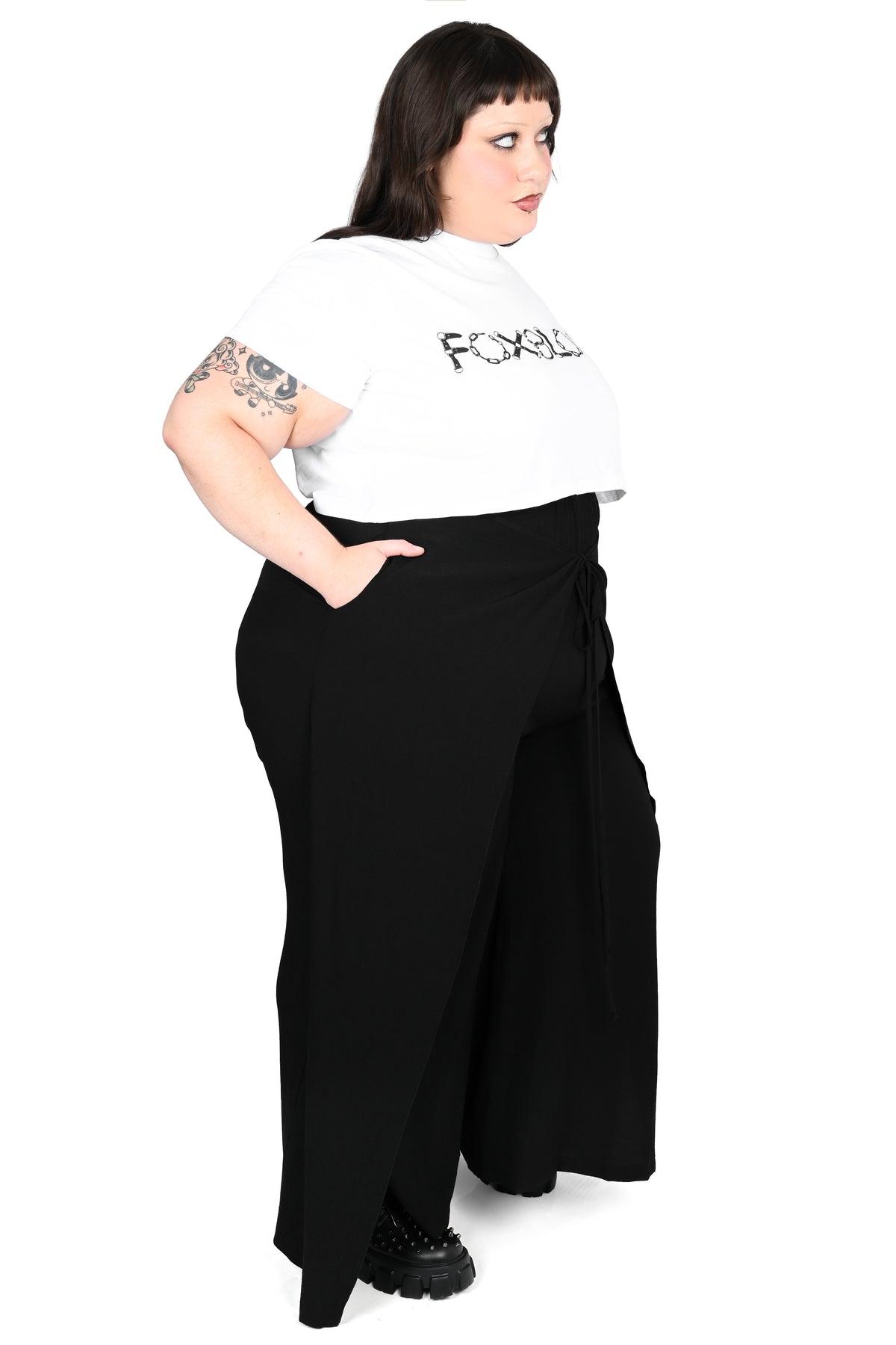 Black wide leg pants featuring a a wrap waist with adjustable tie.