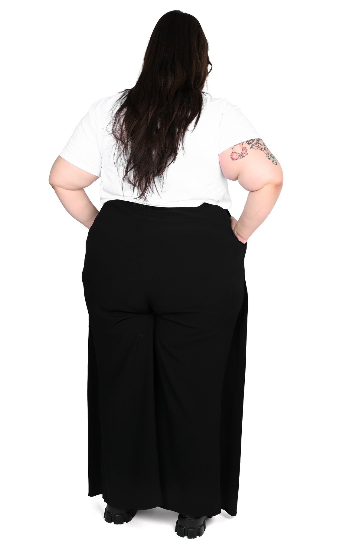 Black wide leg pants featuring a a wrap waist with adjustable tie.
