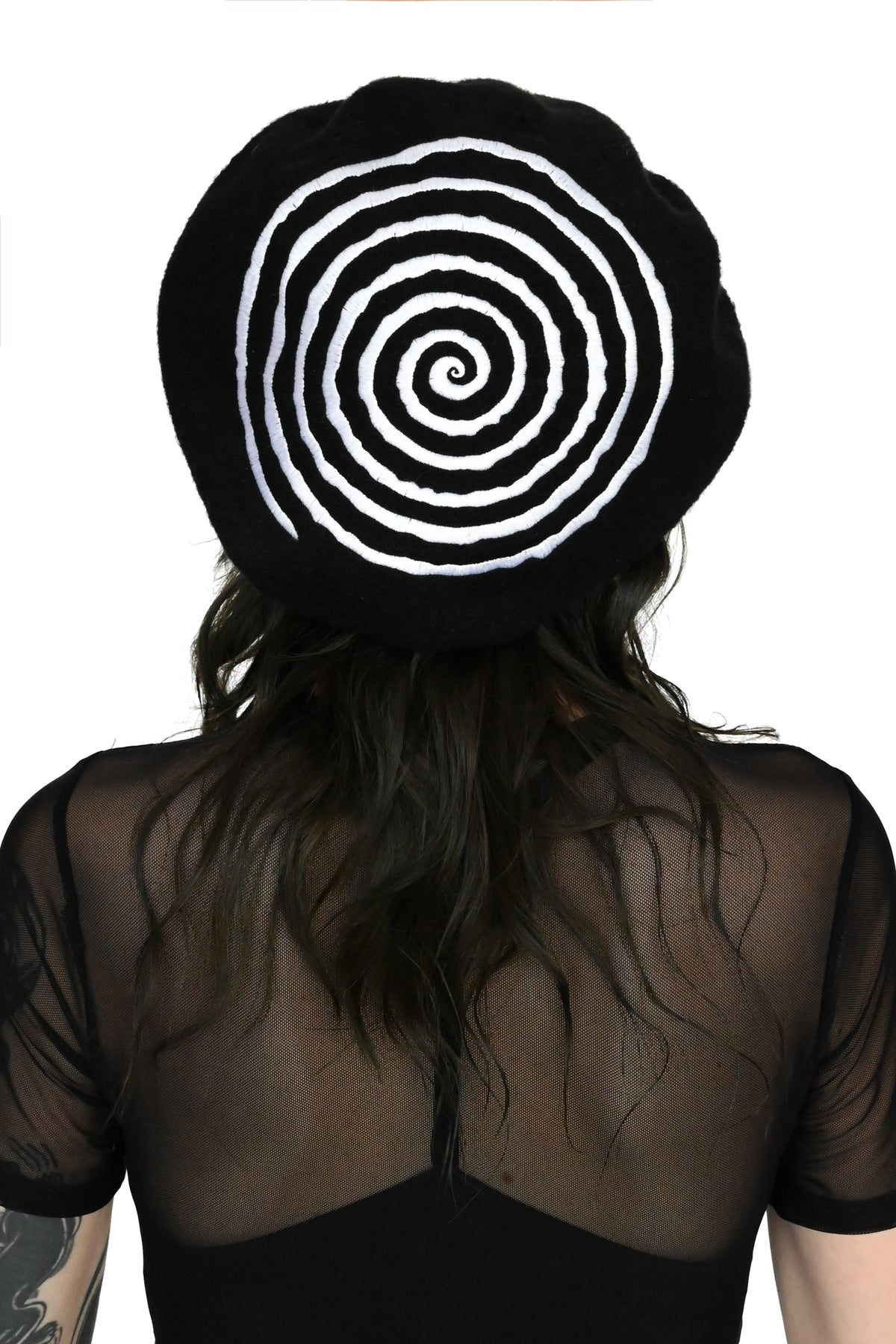 black beret with embroidered white spiral design