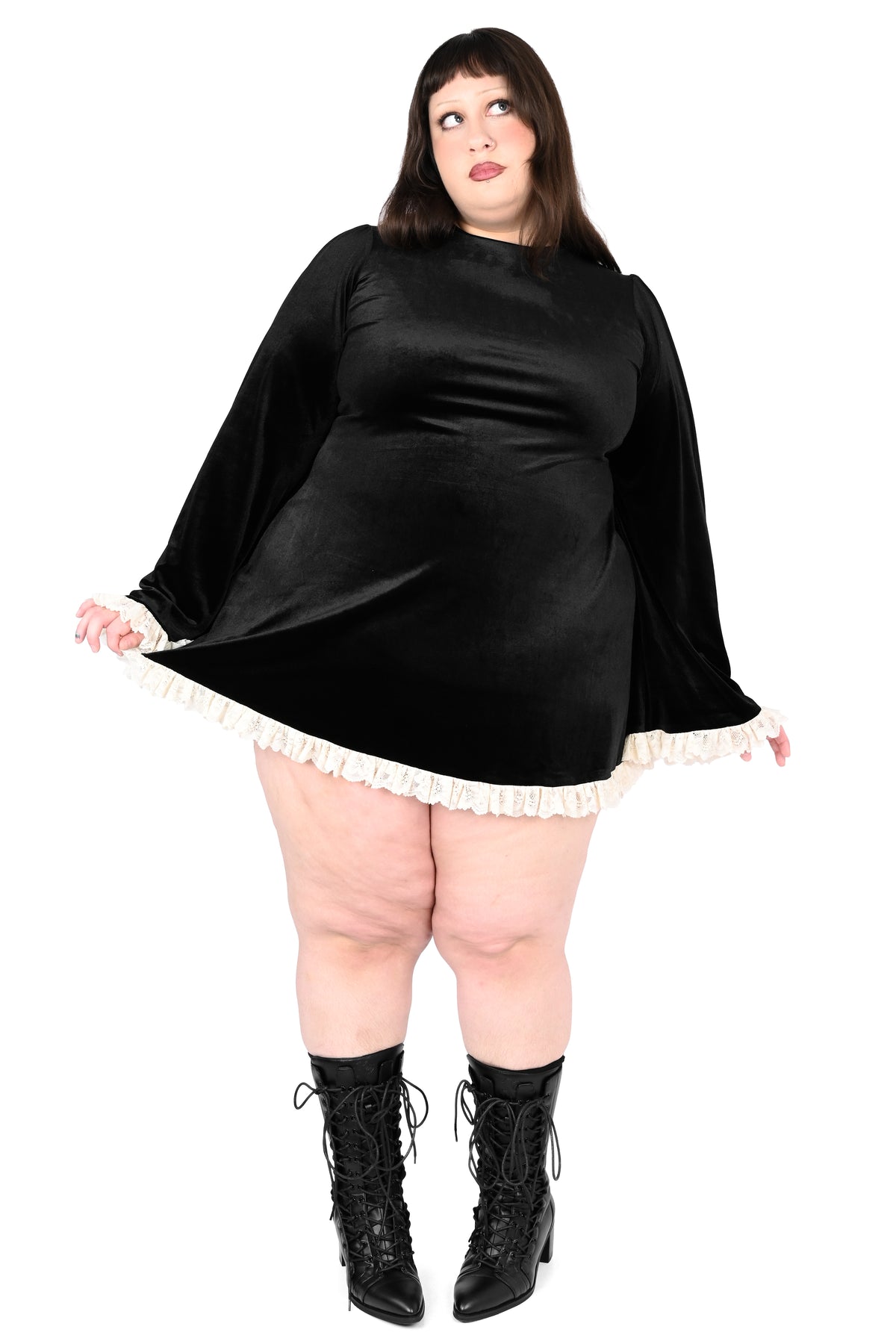 black velevt dress with white lace trim on plus size model 