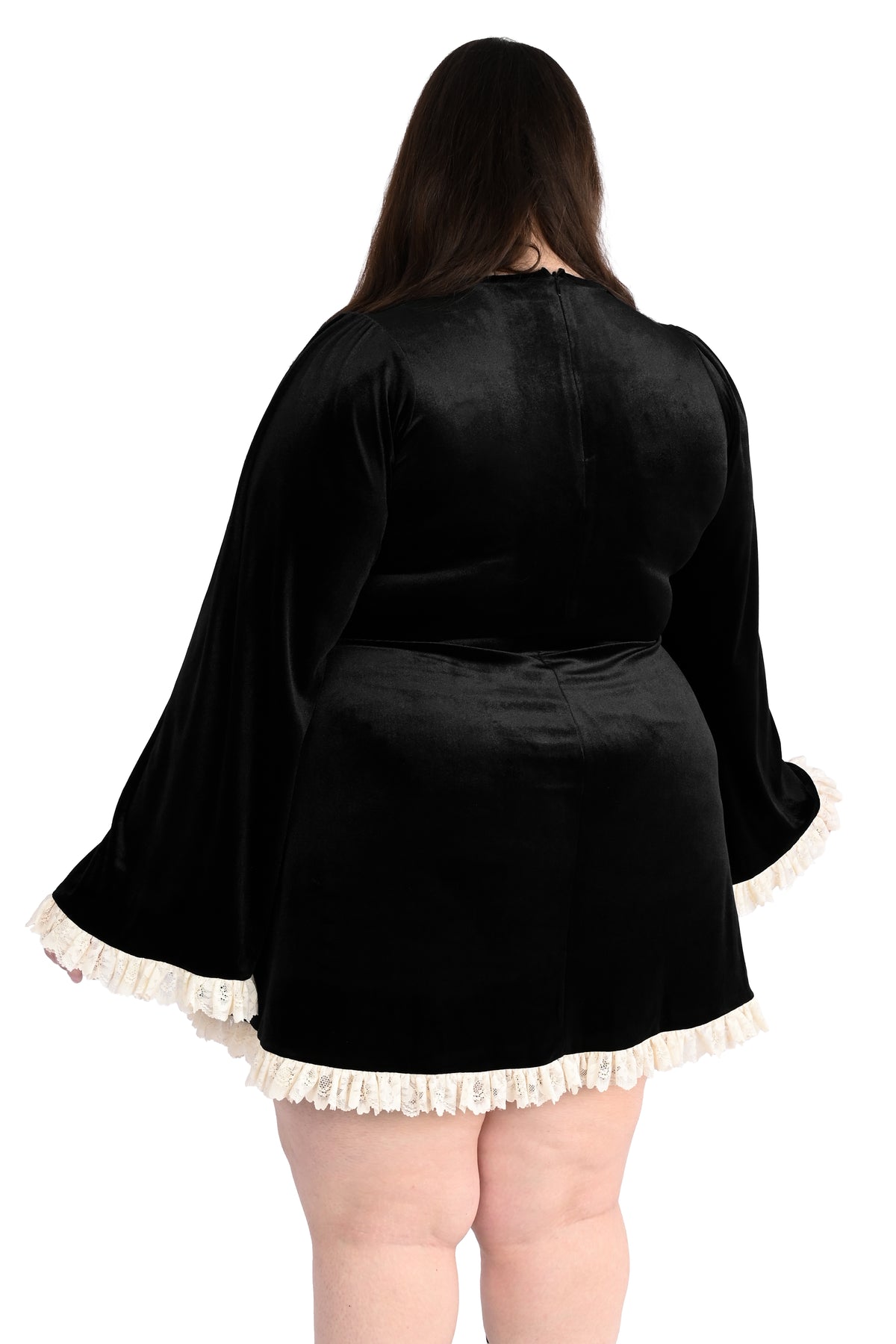 plus size model in a black velvet dress with white lace trim - back shot