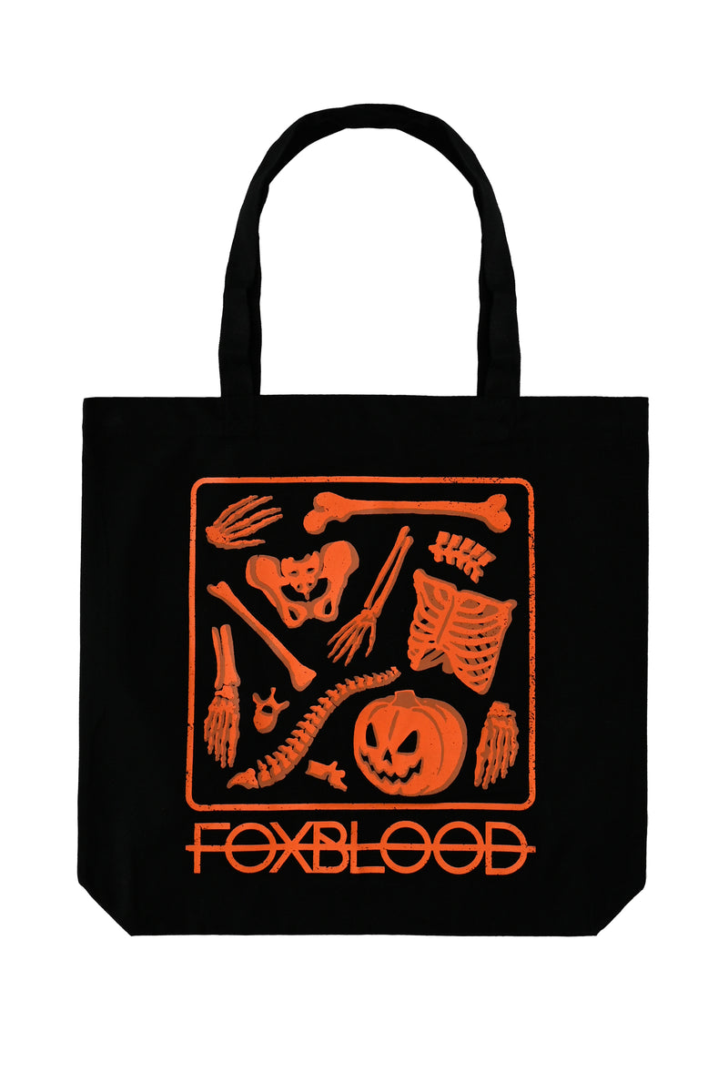 black tote back with orange disassembled jackolantern skeleton print and foxblood logo