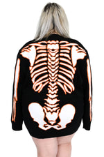 black sweater with orange and glow in the dark white skeleton print on front and back