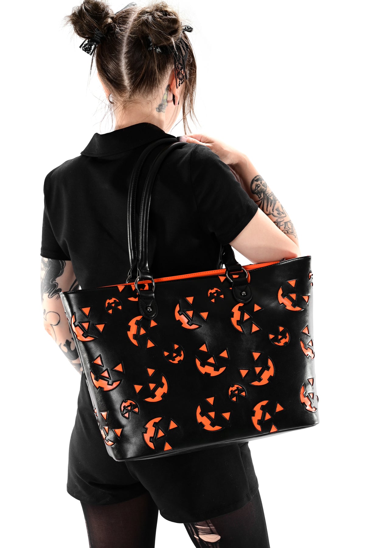 black faux leather tote bag with orange jackolantern face pattern