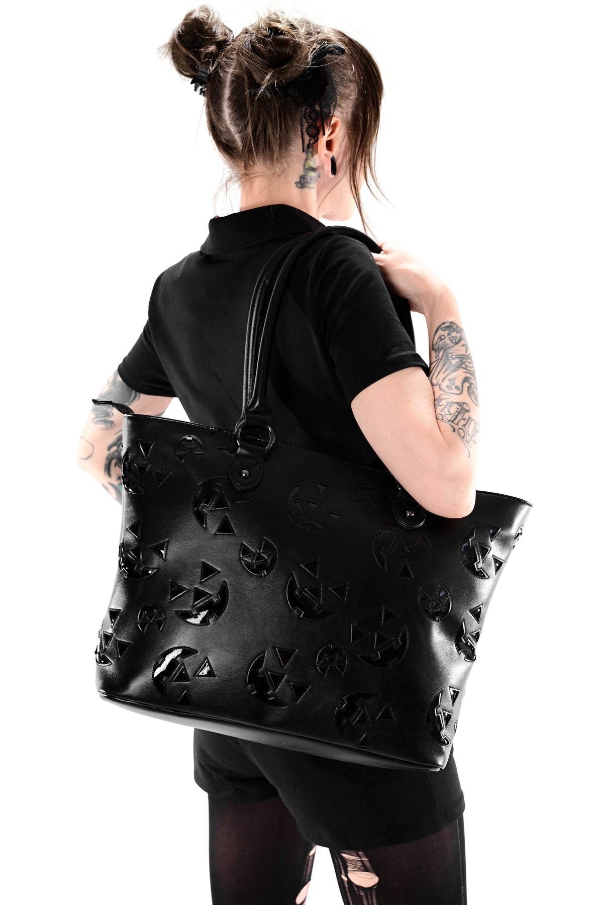 black faux leather tote with patent black jackolantern faces all over