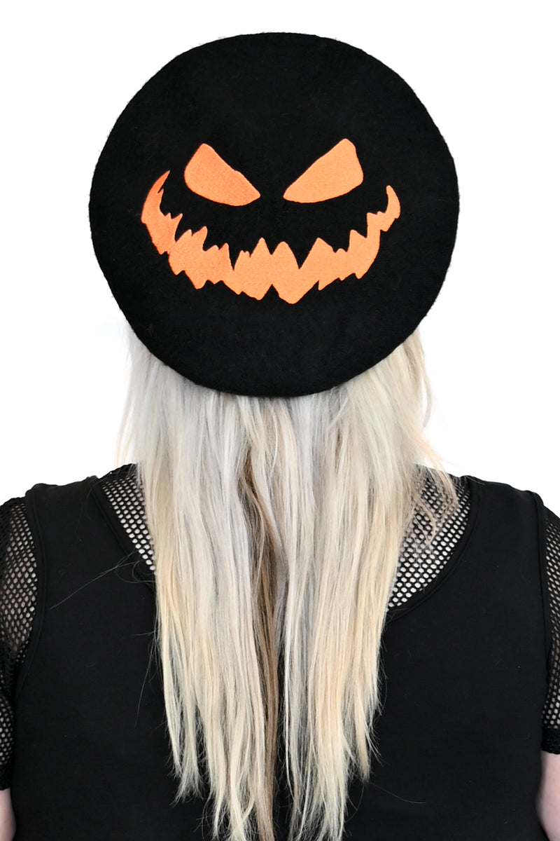 black beret with embroidered orange jackolantern face
