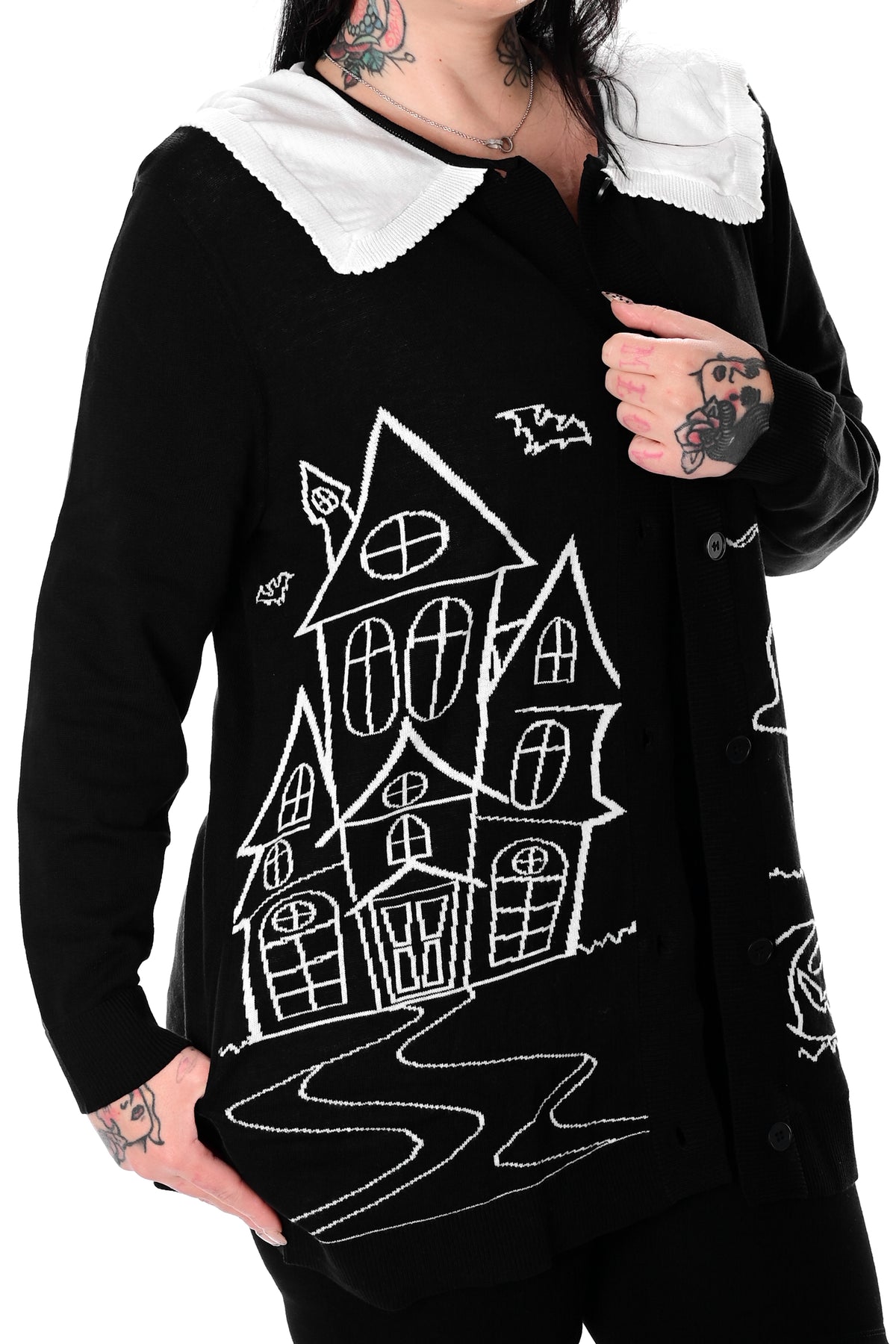 black button up cardigan with white collar and haunted house scene on front