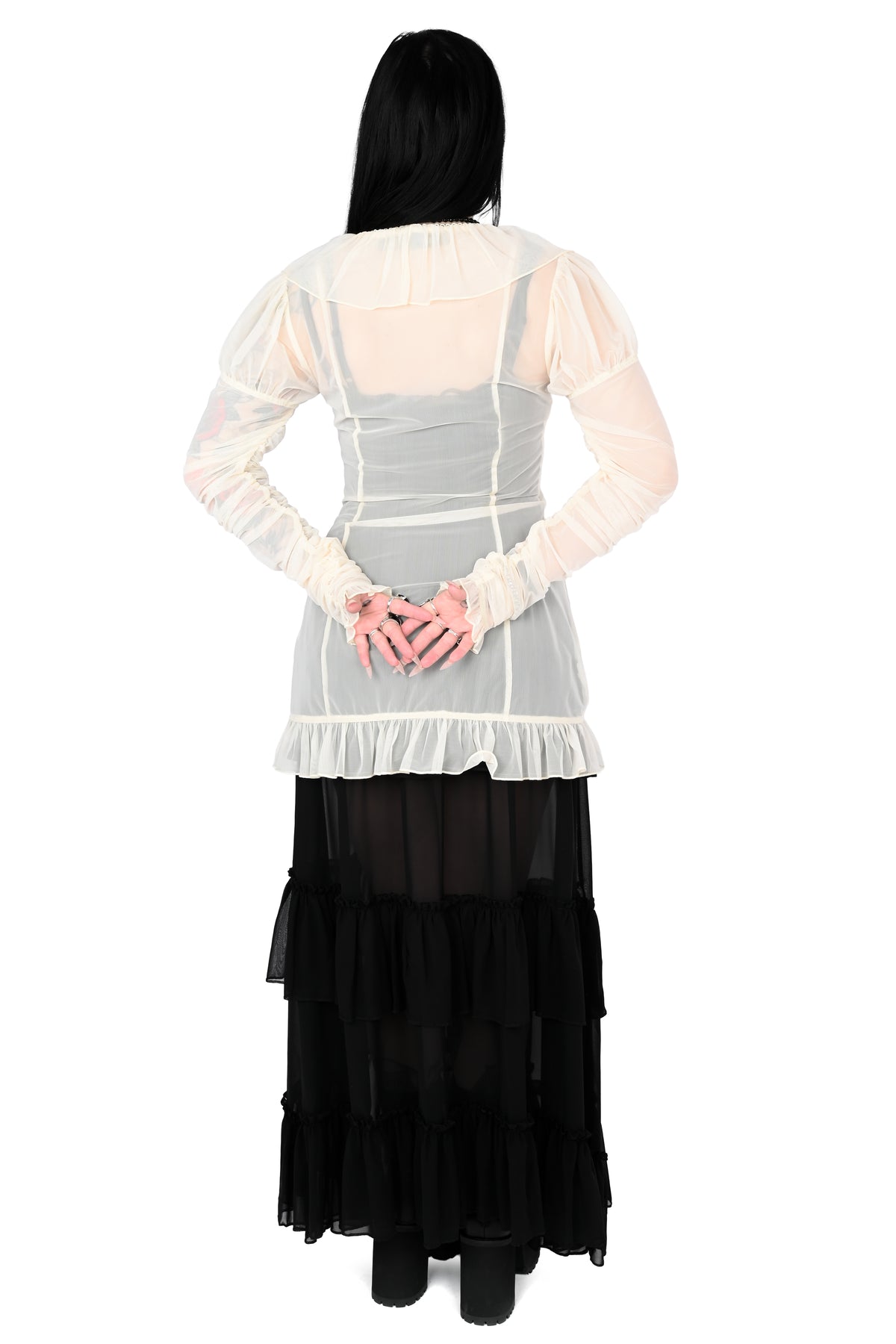 back view of a model wearing a cream sheer ruffle top with satin lace details in size xs
