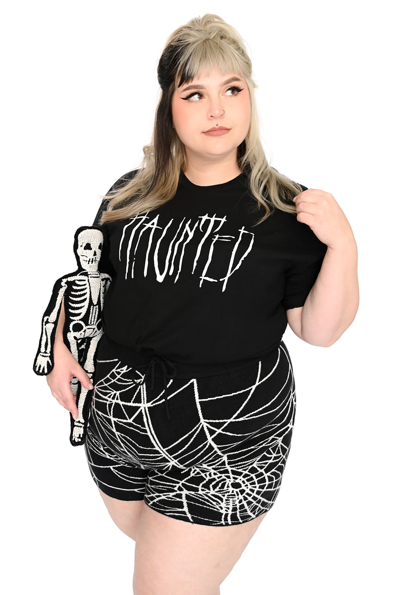 black t-shirt with "haunted" printed on front
