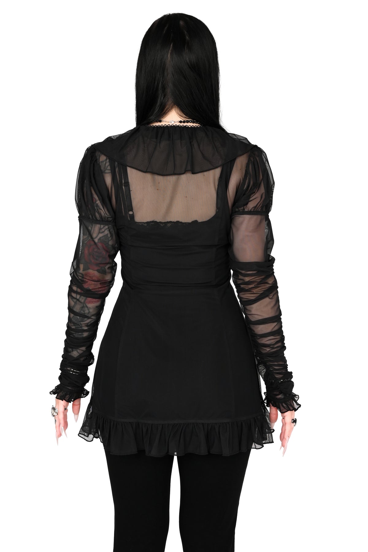 back view of a model wearing a black sheer ruffle top with satin lace details in size xs