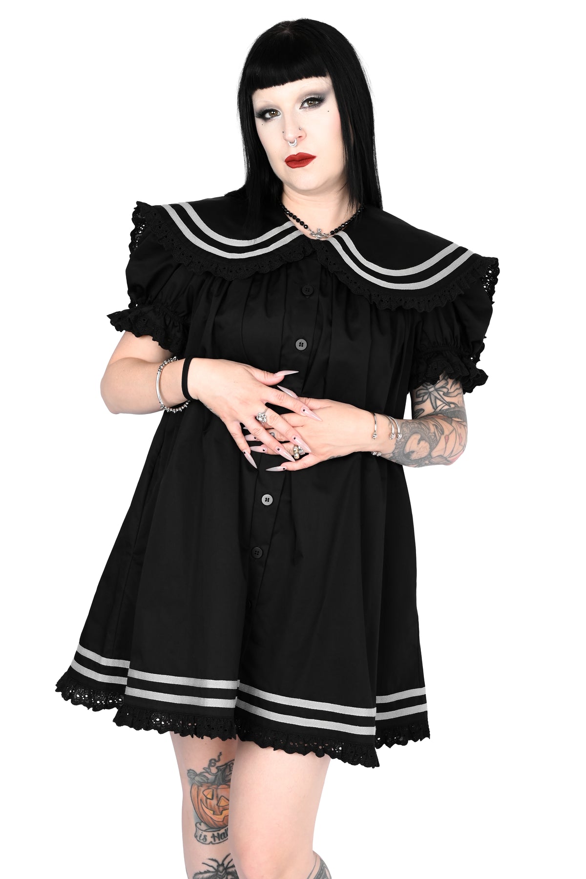 model wearing a black sailor dress with off-white stripe detailing and lace trim in size xs