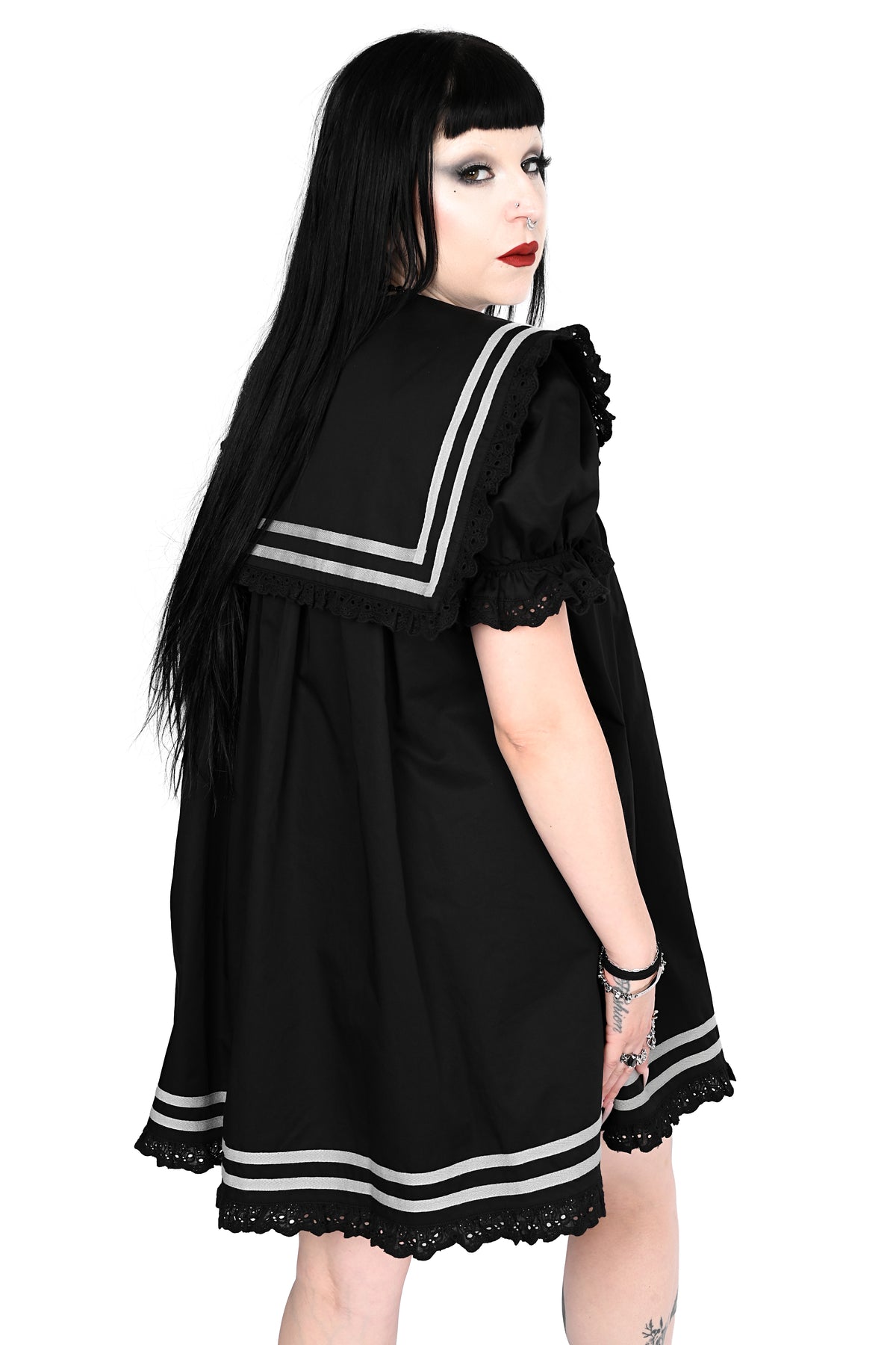 back view of a model wearing a black sailor dress with off-white stripe detailing and lace trim in size xs