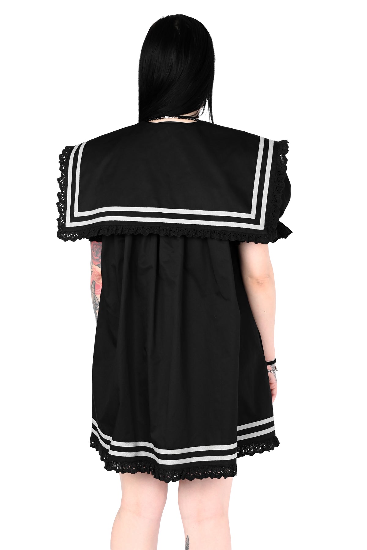 back view of a model wearing a black sailor dress with off-white stripe detailing and lace trim in size xs