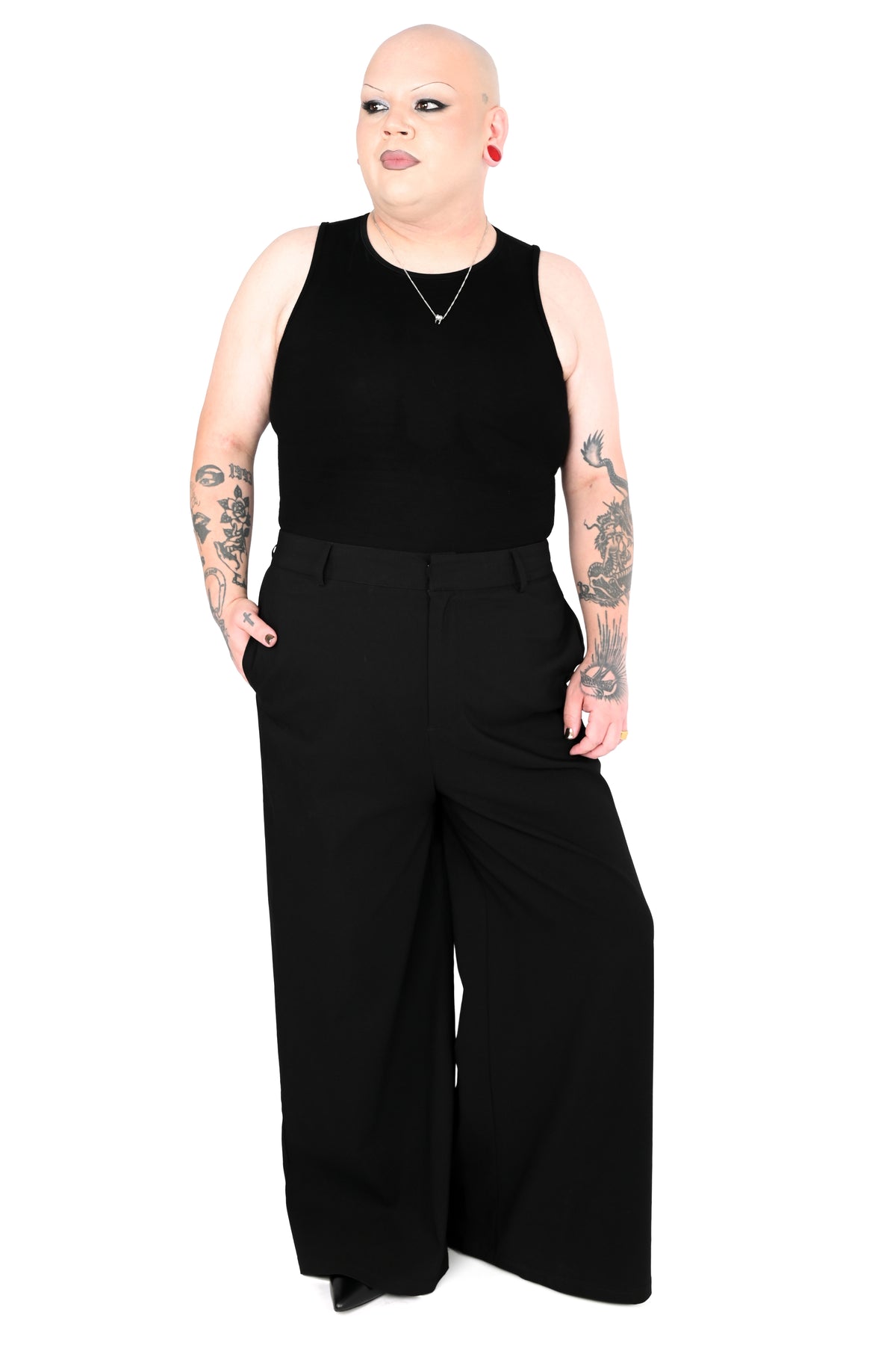 model wearing black high waisted wide leg pants with a sleeveless mock neck top in size 2xl