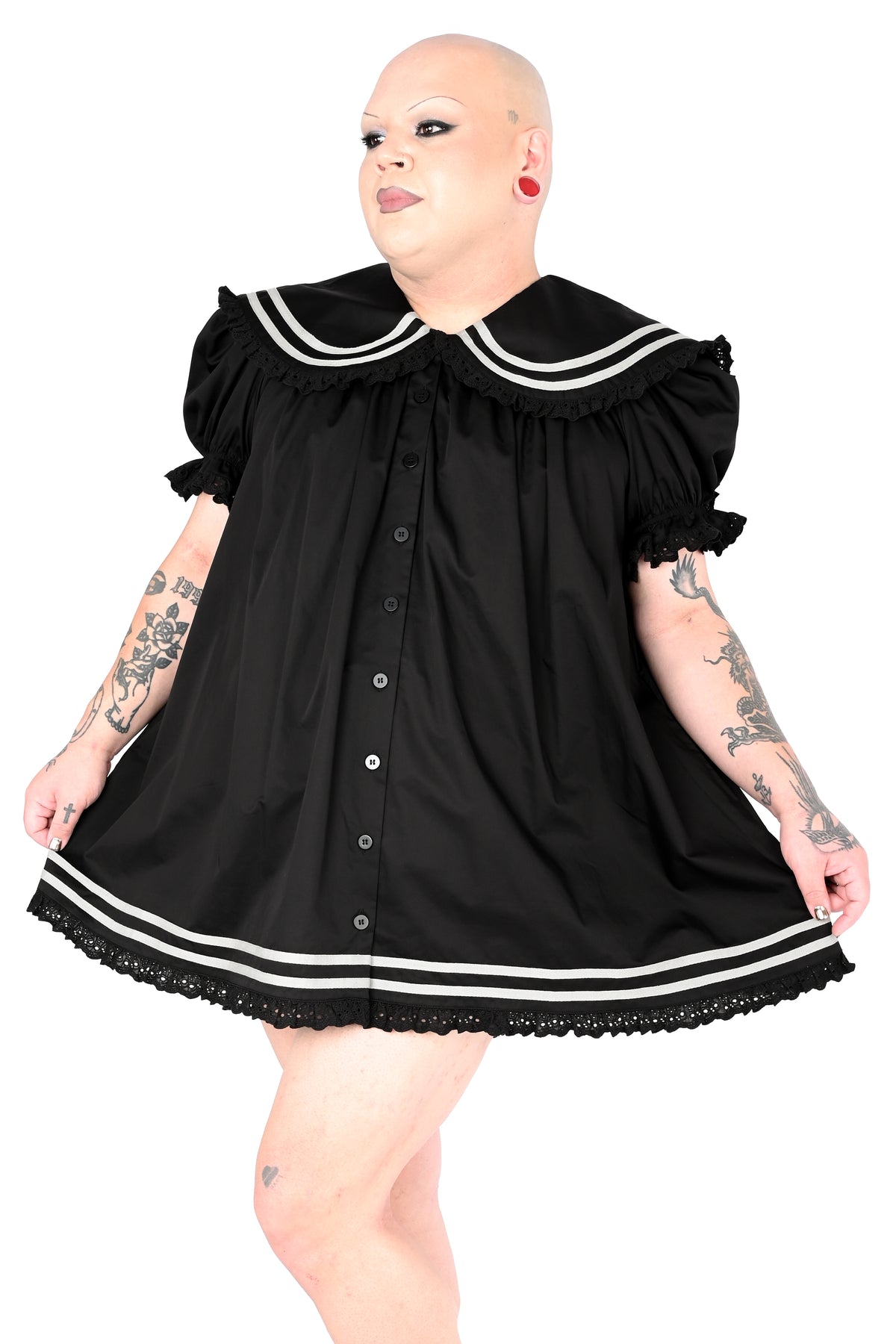 model wearing a black sailor dress with off-white stripe detailing and lace trim in size 2xl, posed against a white background
