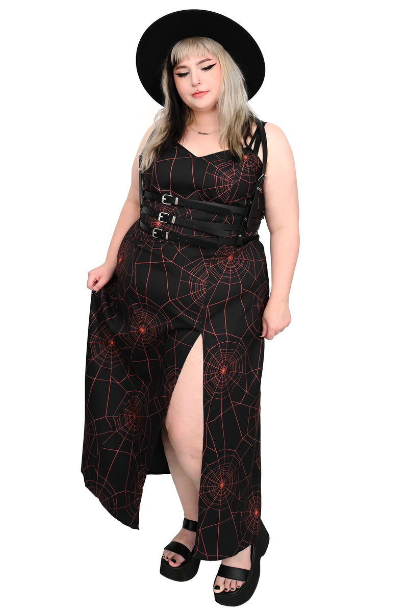 black maxi slip dress with all over orange spiderweb print with side slit