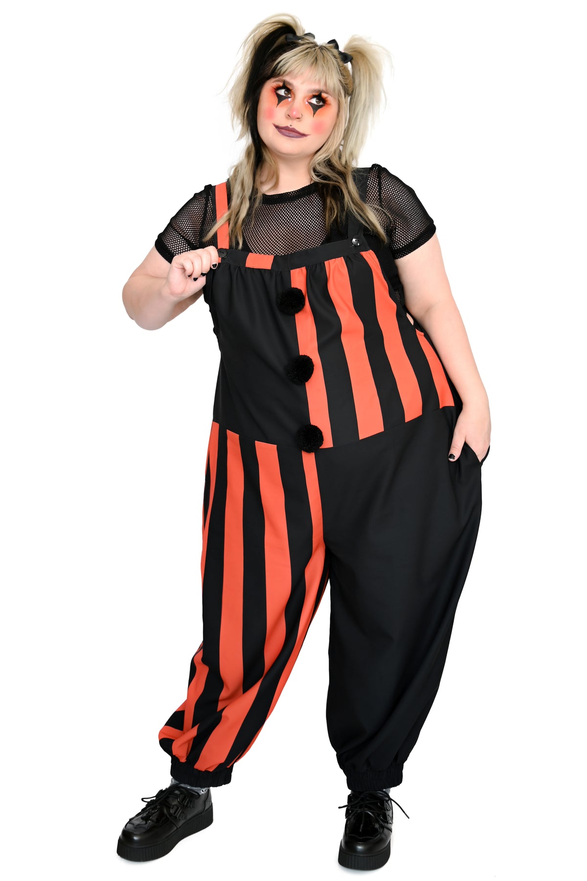 black and orange striped colorblocked overalls with black pompoms