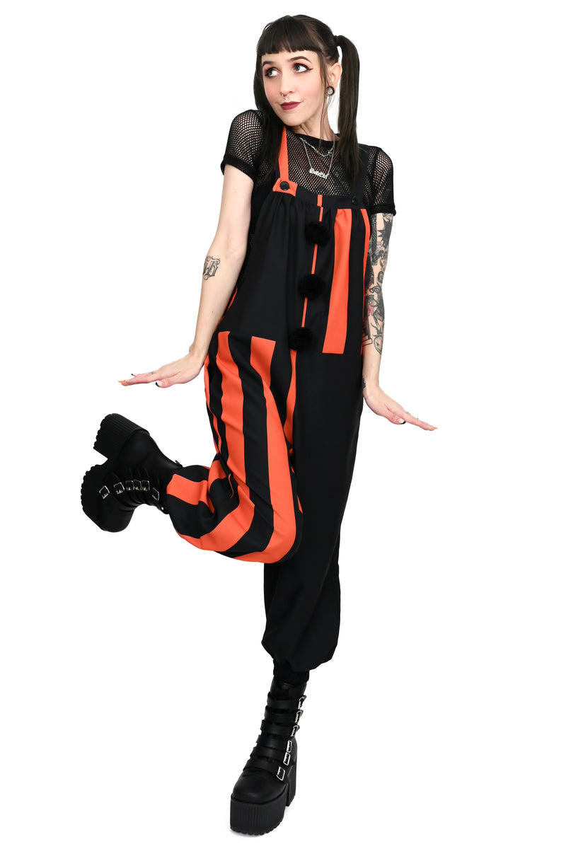 black and orange striped colorblocked overalls with black pompoms