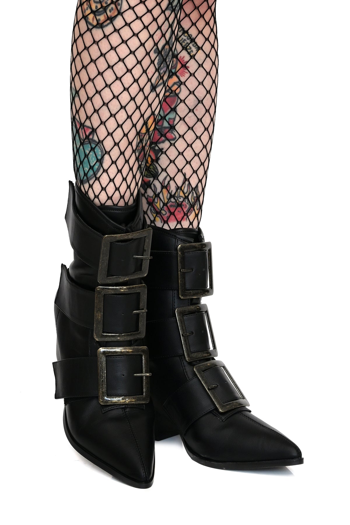 black pointed toe boots with large brass buckles
