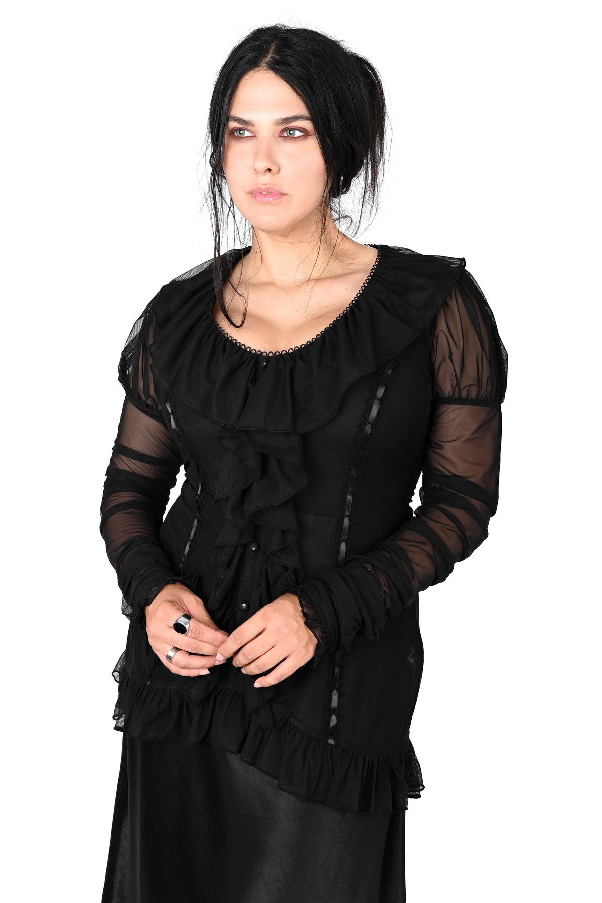 A woman modeling a black long-sleeve gothic-style top with sheer mesh sleeves, ruffled details, and a scoop neckline, set against a plain white background.