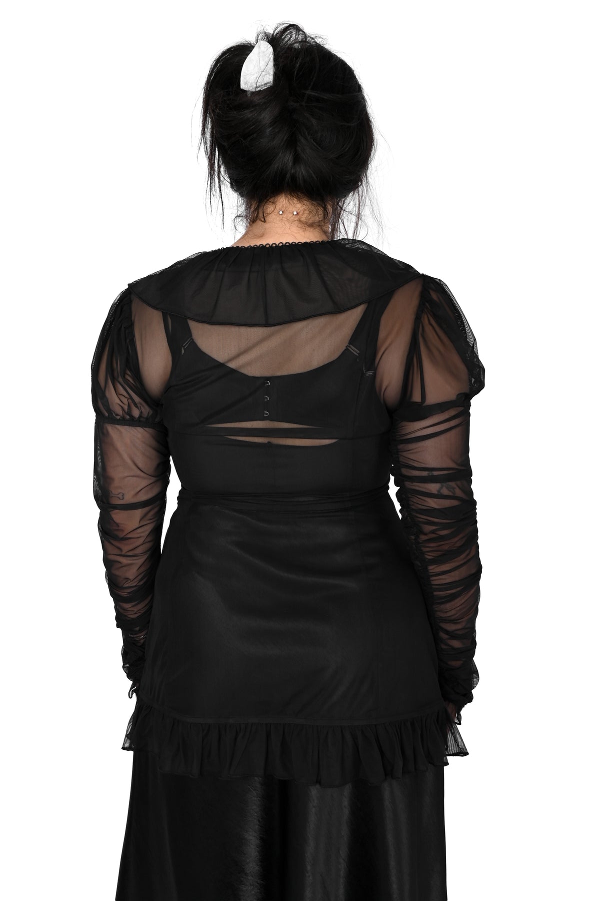 back view of a model wearing a black sheer ruffle top with satin lace details in size medium