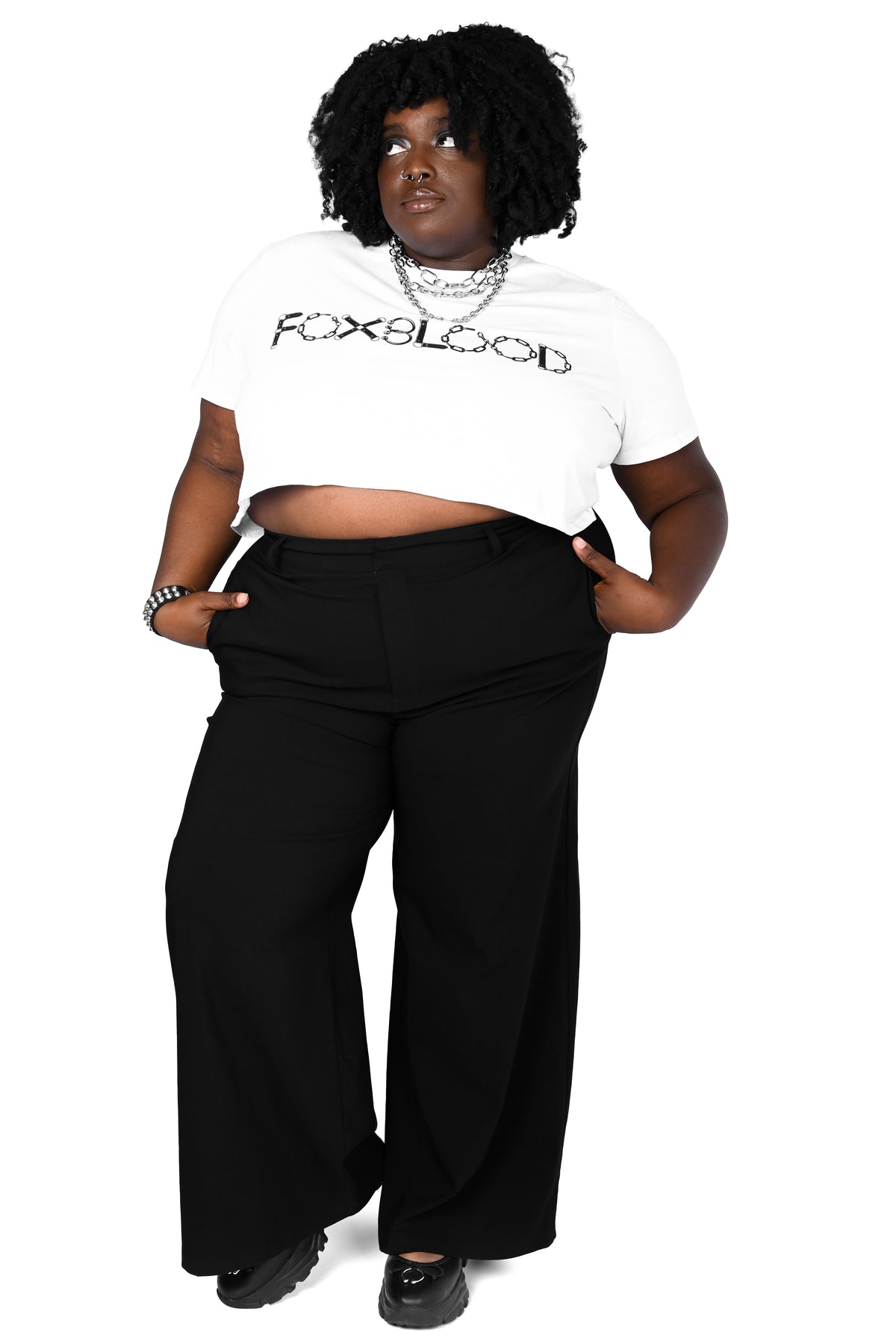 model wearing black high waisted wide leg pants with a white foxblood logo tee in size 3xl