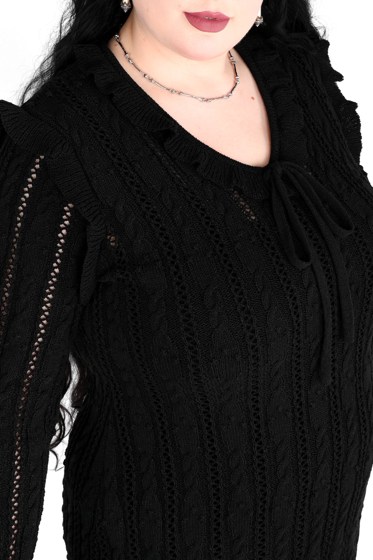 Black sweater dress with cute ruffly shoulders, bottom hem and tie neckline.