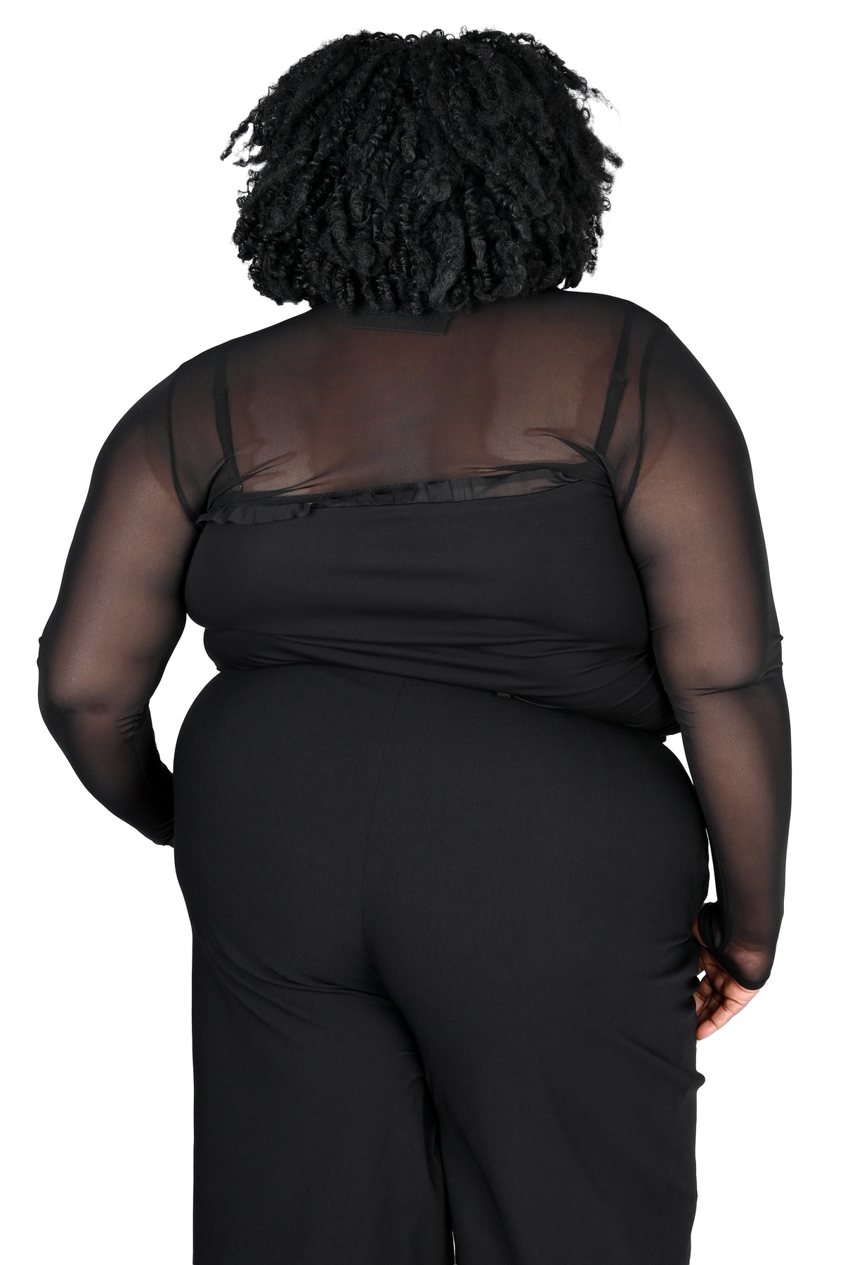 A person shown from the back wearing a black sheer mesh bolero with a spaghetti strap top and black wide-leg pants, photographed against a plain white background.
