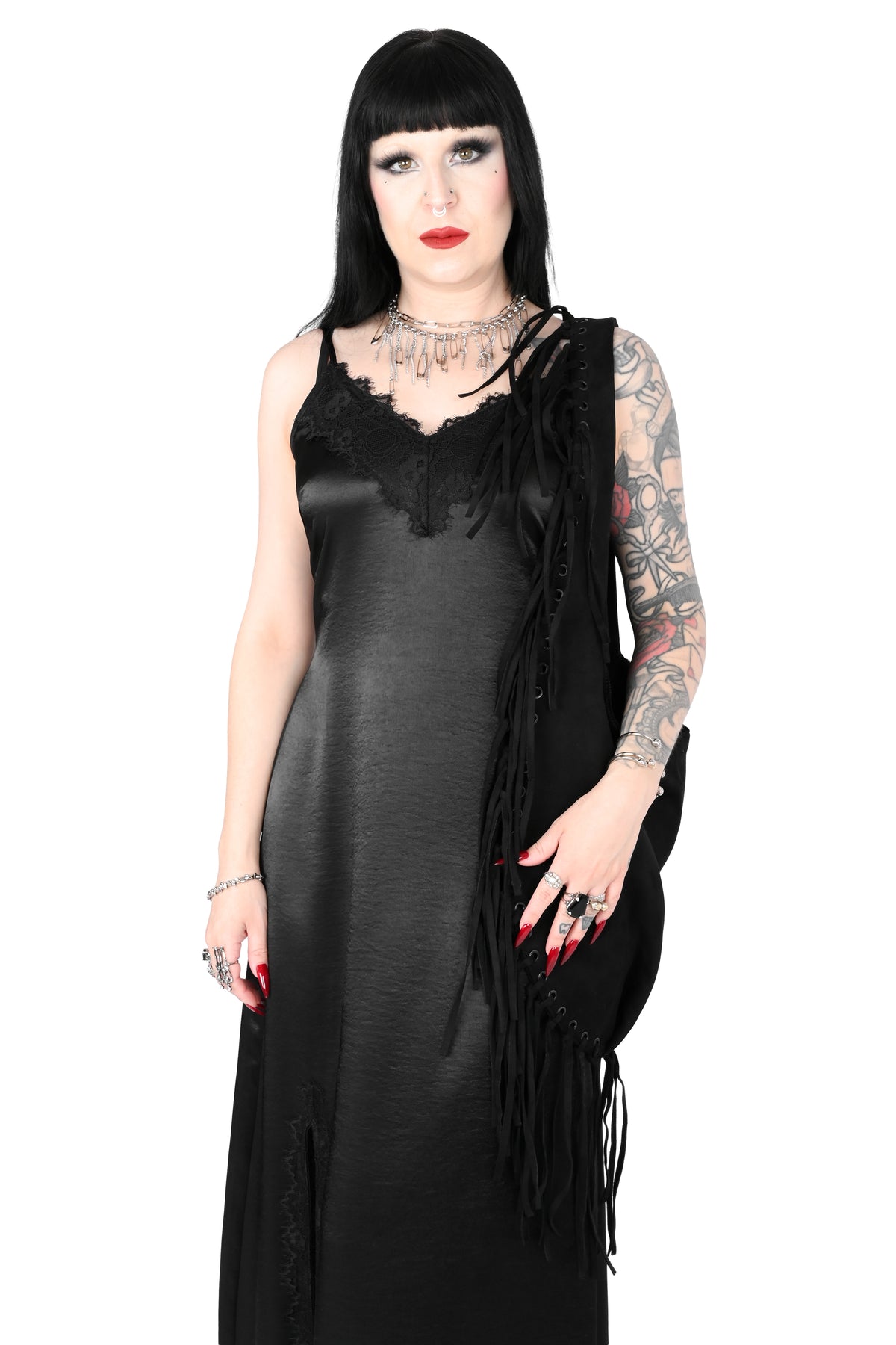 Black faux suede shoulder bag with fringe trim all around.