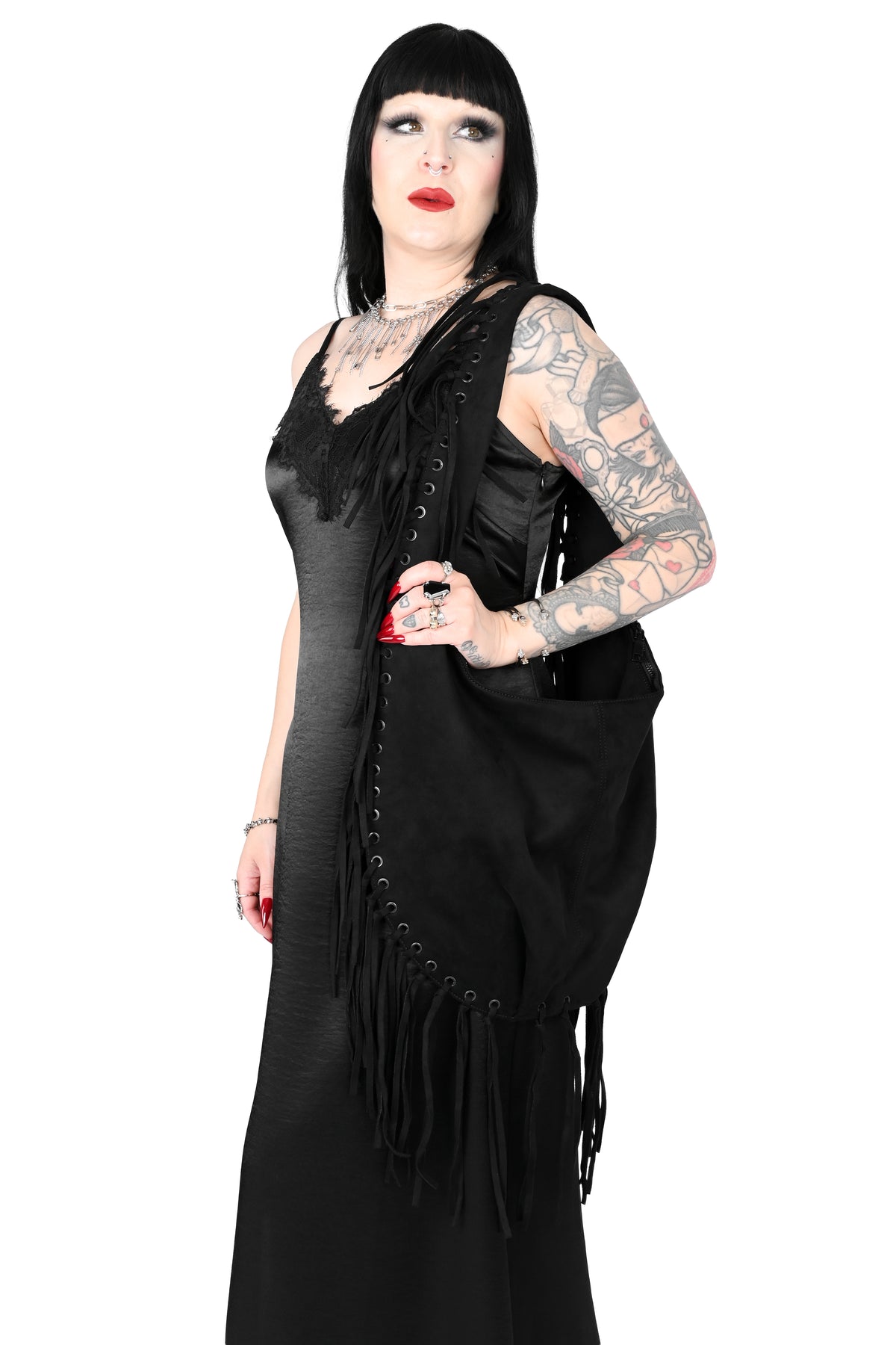 Black faux suede shoulder bag with fringe trim all around.