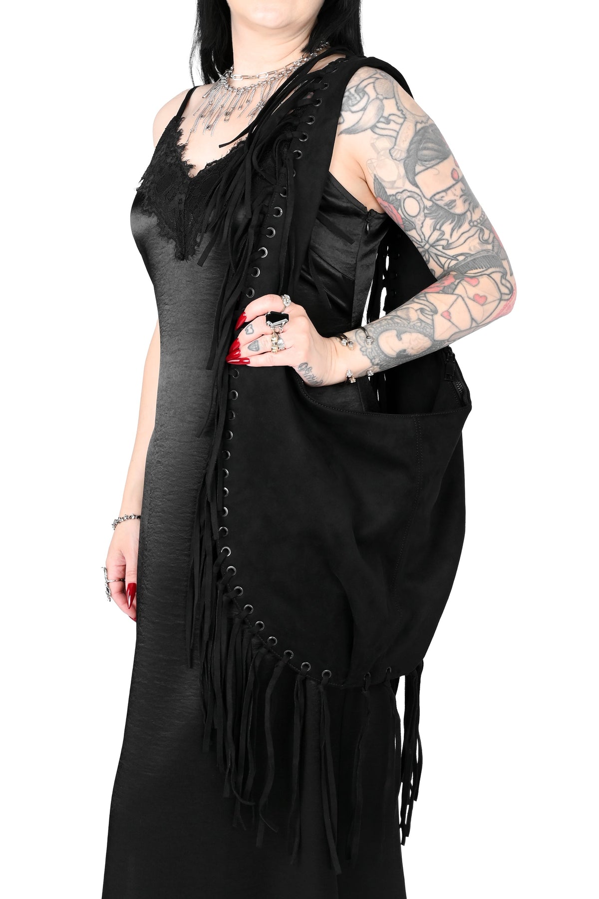 Black faux suede shoulder bag with fringe trim all around.