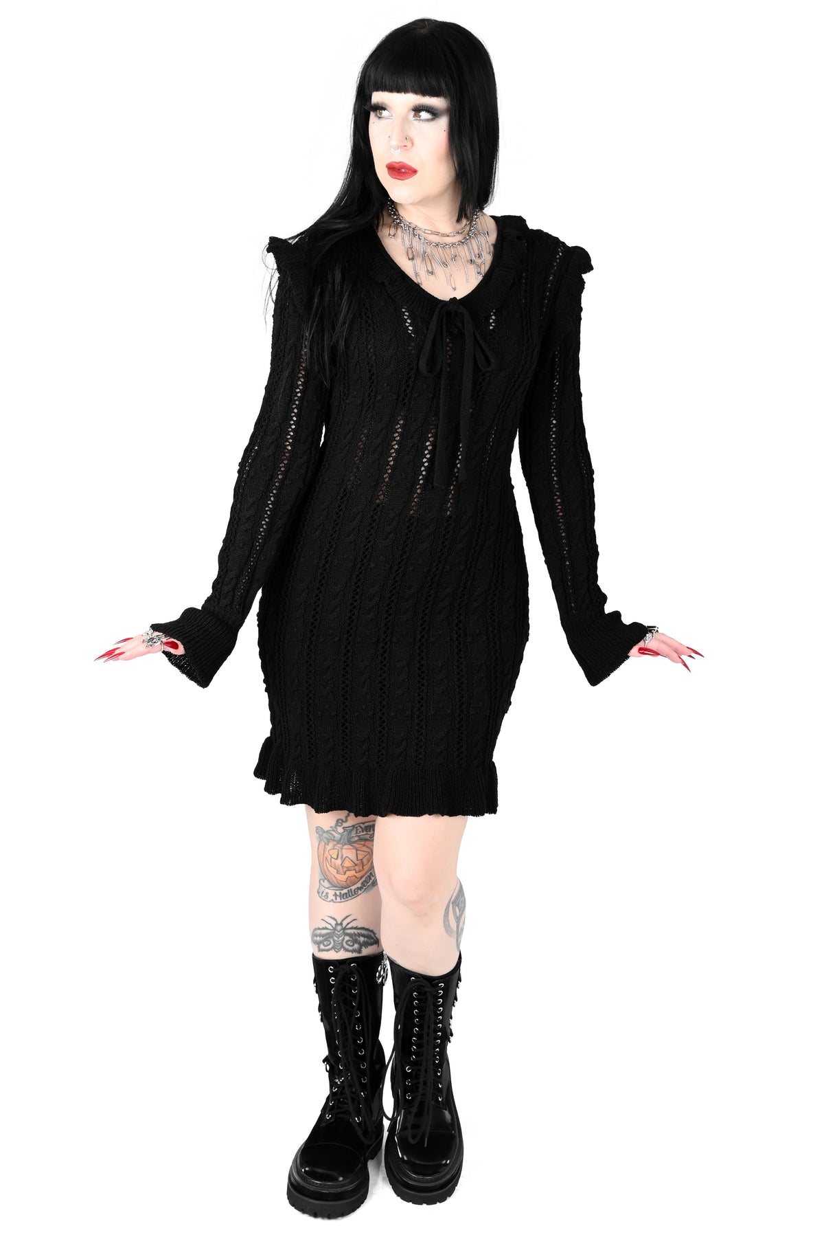 Black sweater dress with cute ruffly shoulders, bottom hem and tie neckline.