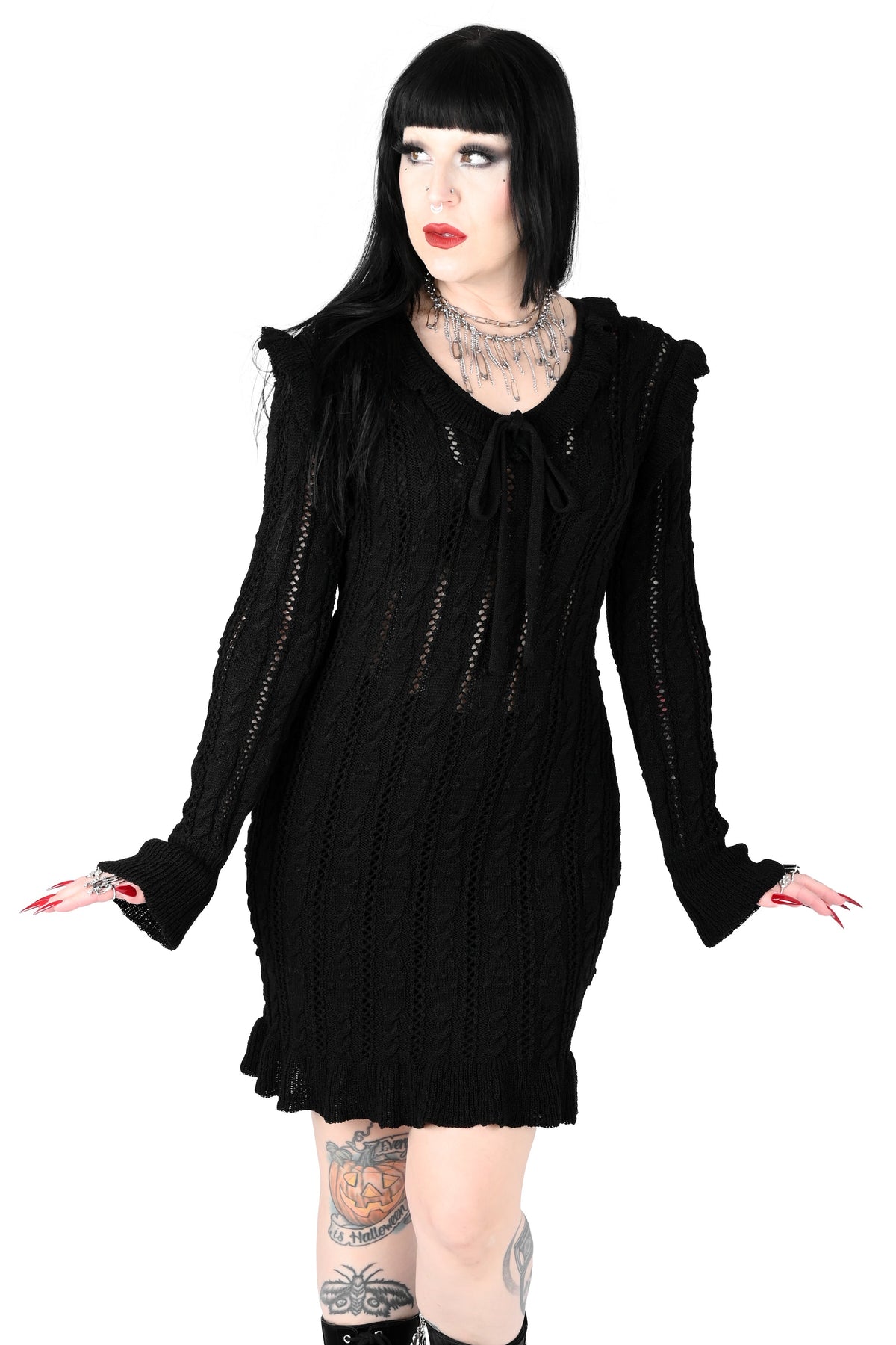 Black sweater dress with cute ruffly shoulders, bottom hem and tie neckline.