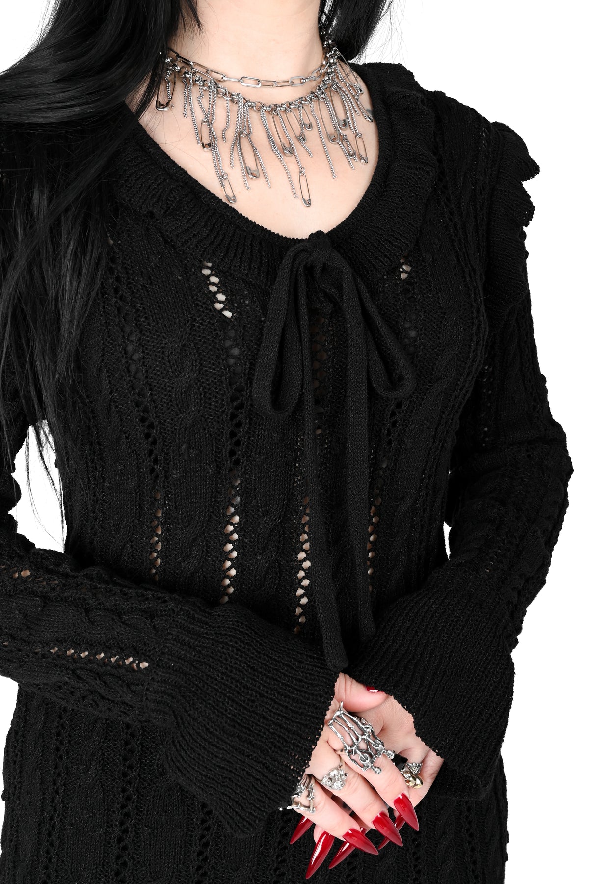 Black sweater dress with cute ruffly shoulders, bottom hem and tie neckline.