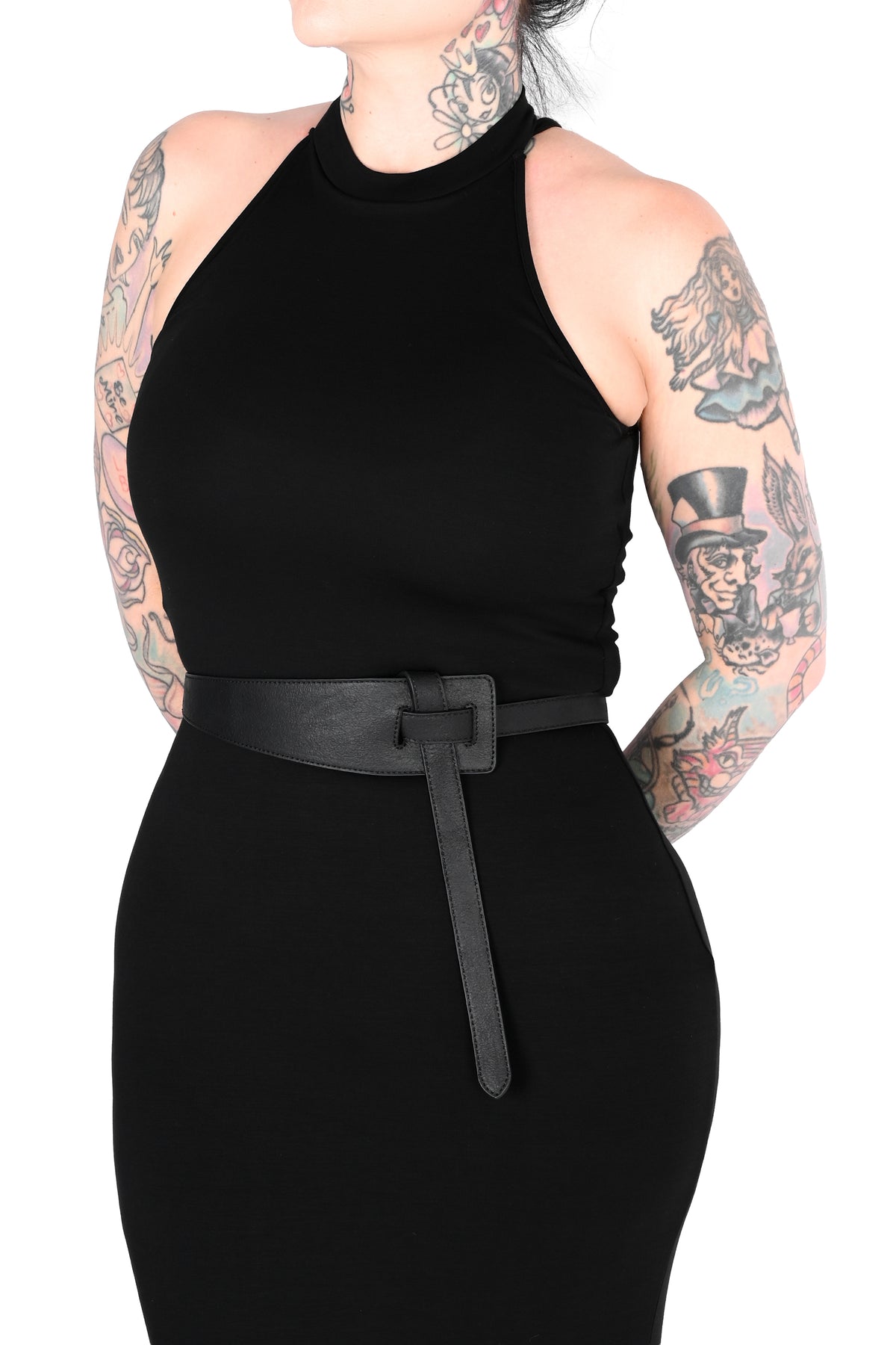 A model wearing a black sleeveless halter-neck dress with a matching black belt, shown from the neck down against a plain white background.