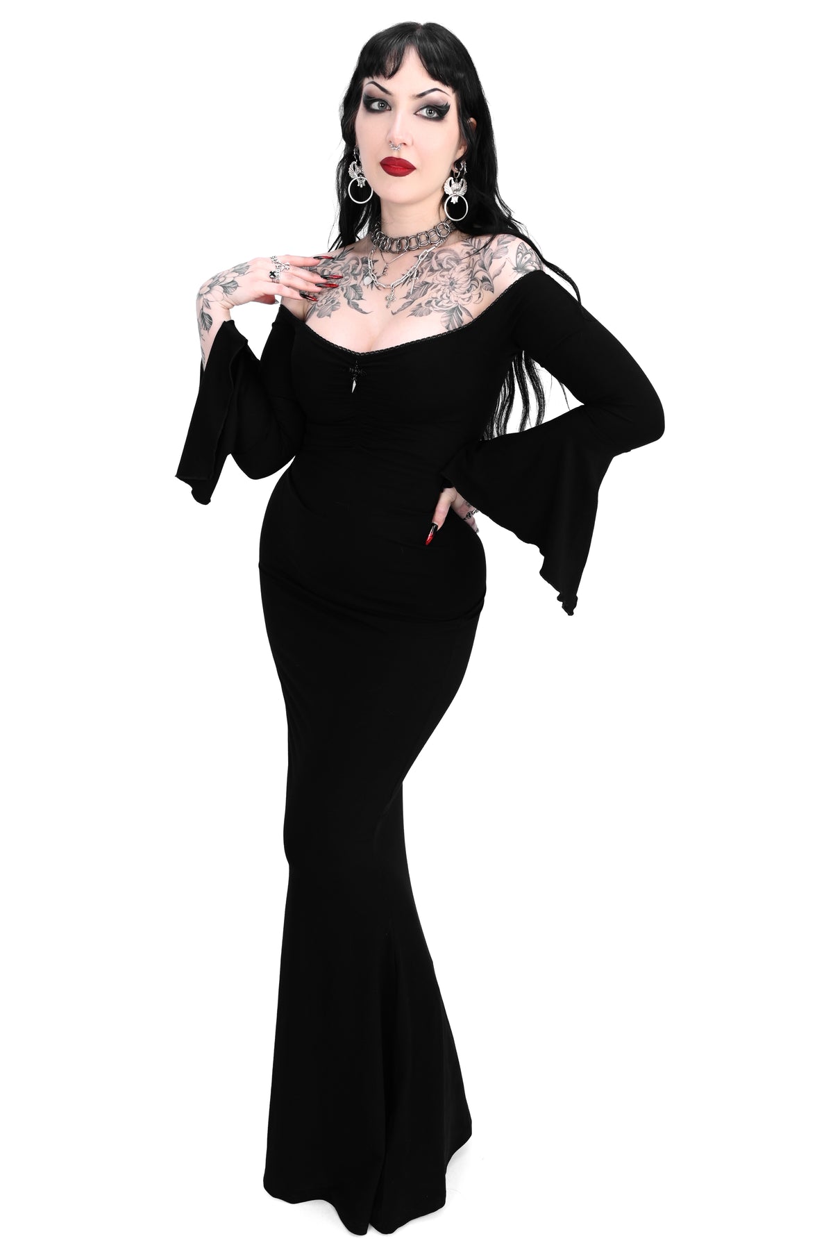 black bell sleeve off the shoulder maxi dress with flared bottom and dagger pendant in the middle of the neckline