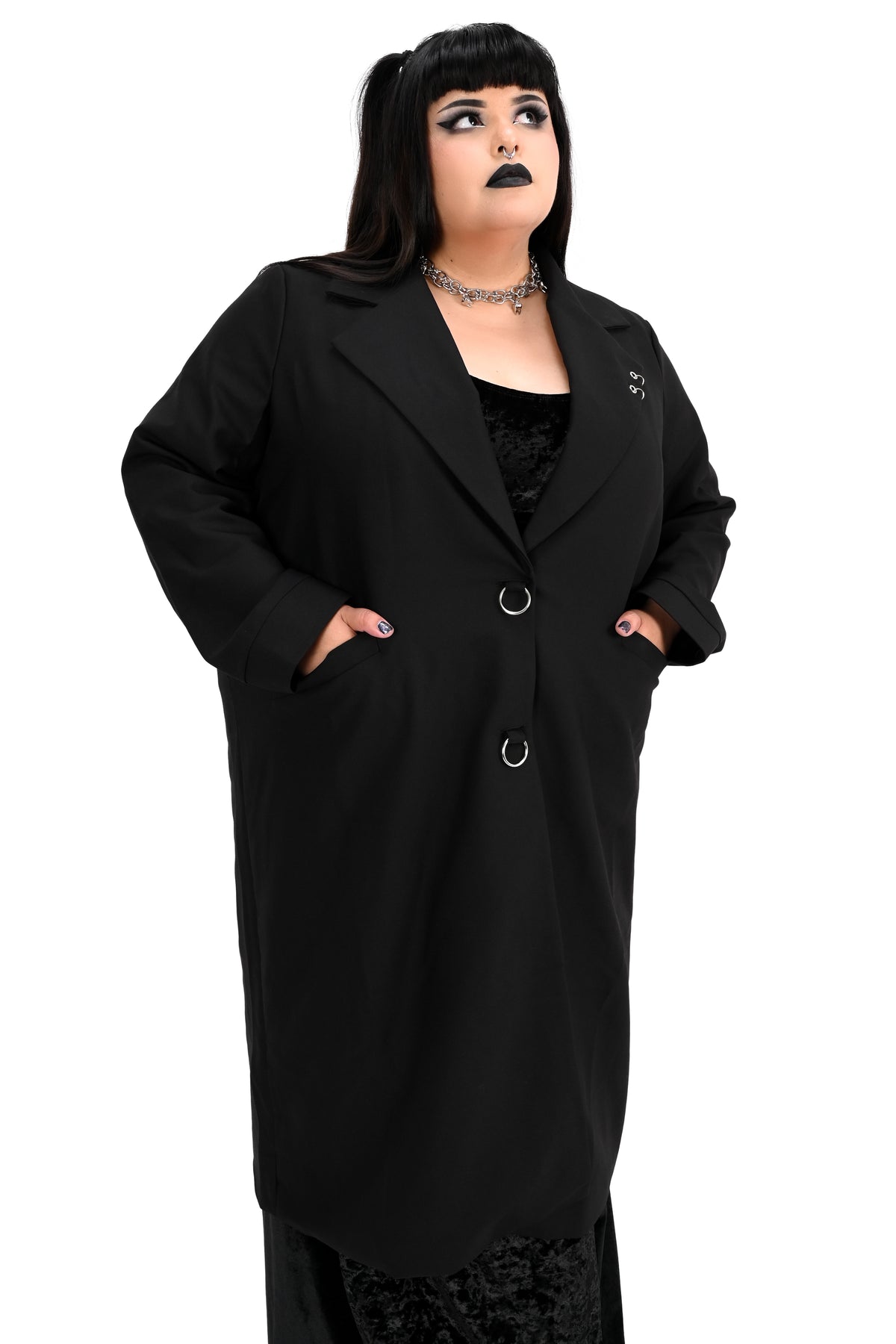 Long black trench coat with two o-ring piercing details on the left lapel