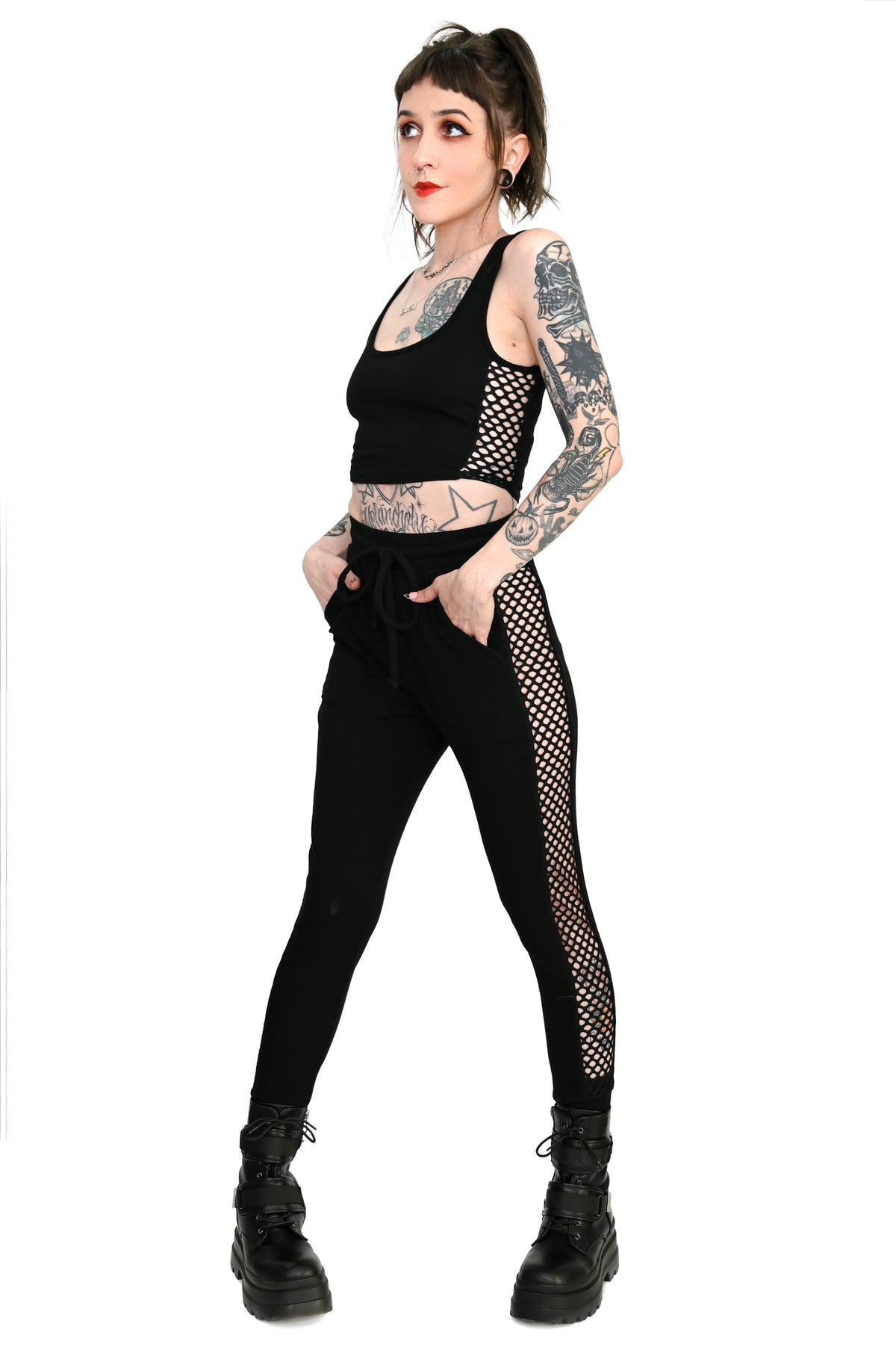 black jogger and crop top set with fishnet panels down the sides of each piece