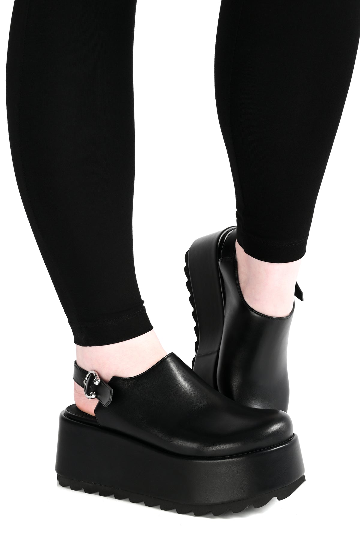 black platform clogs with a horseshoe piercing buckle