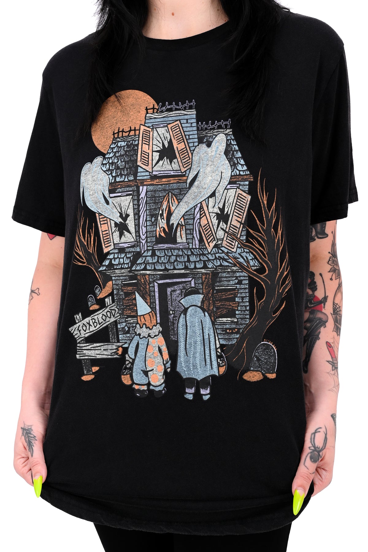 vintage black tee feature a haunted house with ghosts and two trick or treaters