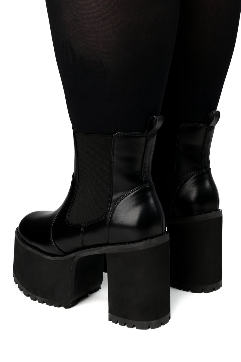 Black pull on PU leather platform Chelsea boots with elastic side panels 
