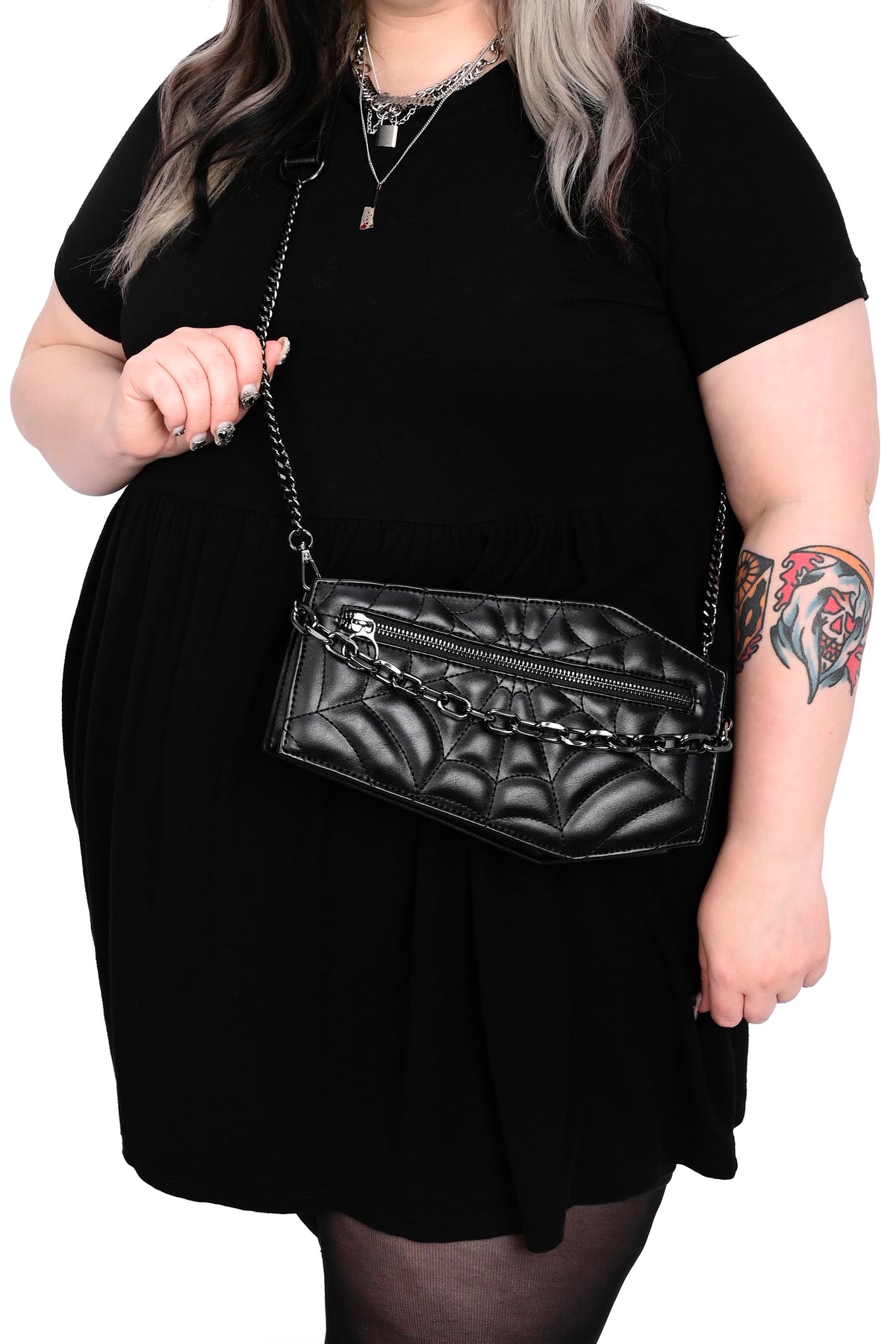 black coffin crossbody bag with black spiderweb stitching and silver chain detail